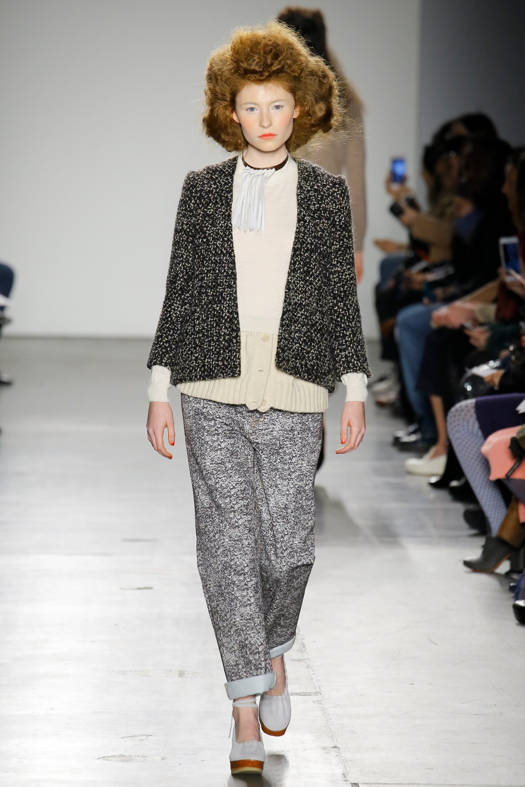 A relaxed black jacket paired with printed pants, featuring a collared design and long sleeves.