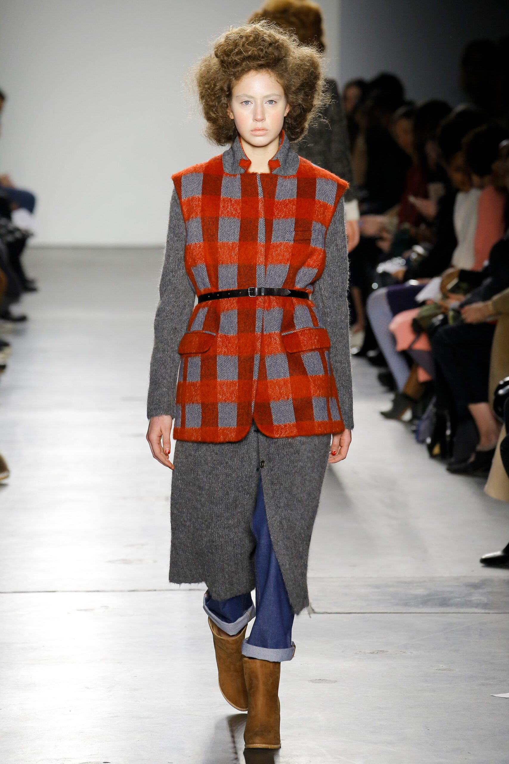 A relaxed gray and red checked coat with a belted waist and long sleeves.