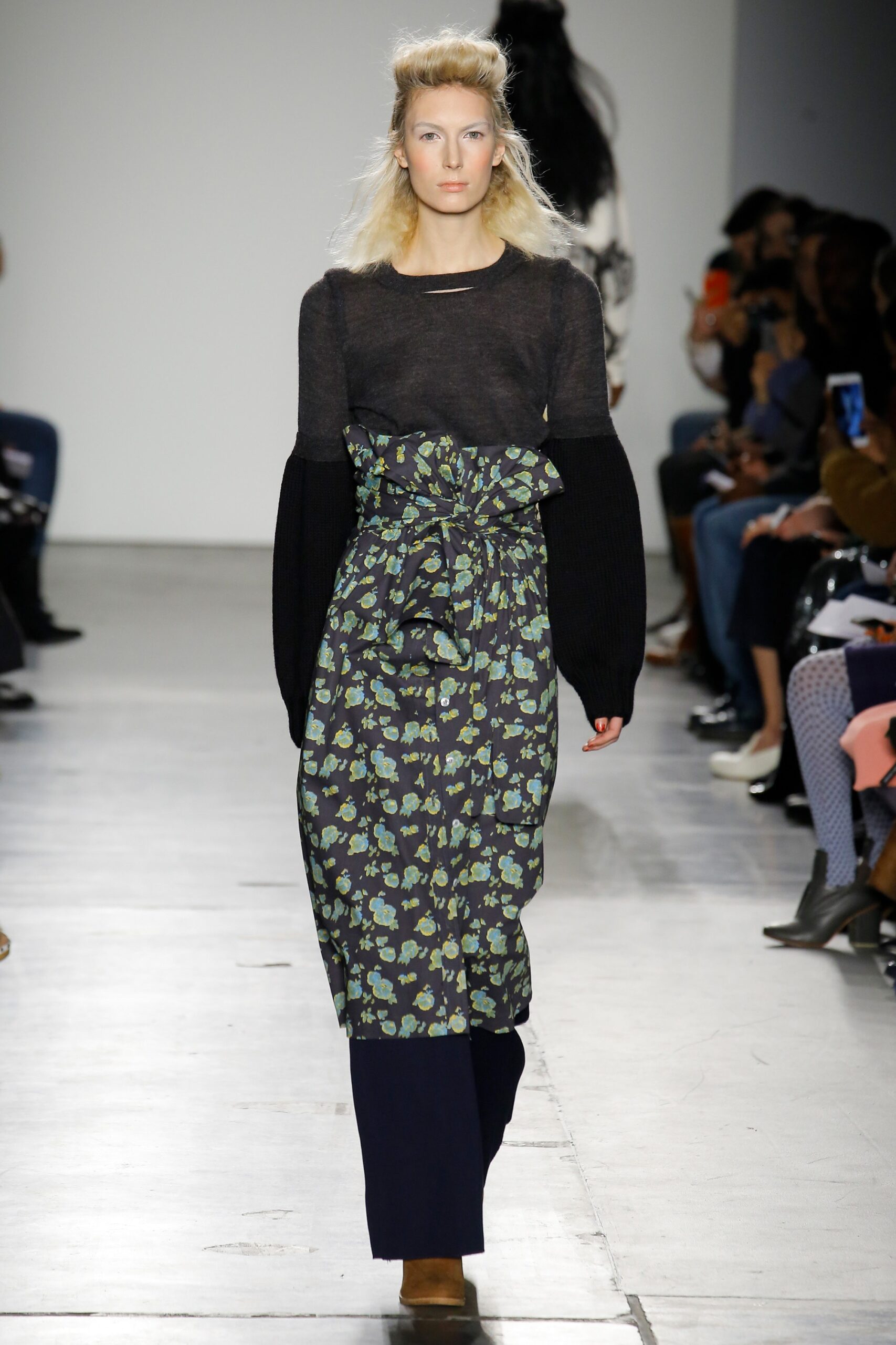 A relaxed floral dress with long sleeves and a V-neckline, featuring a tiered design.