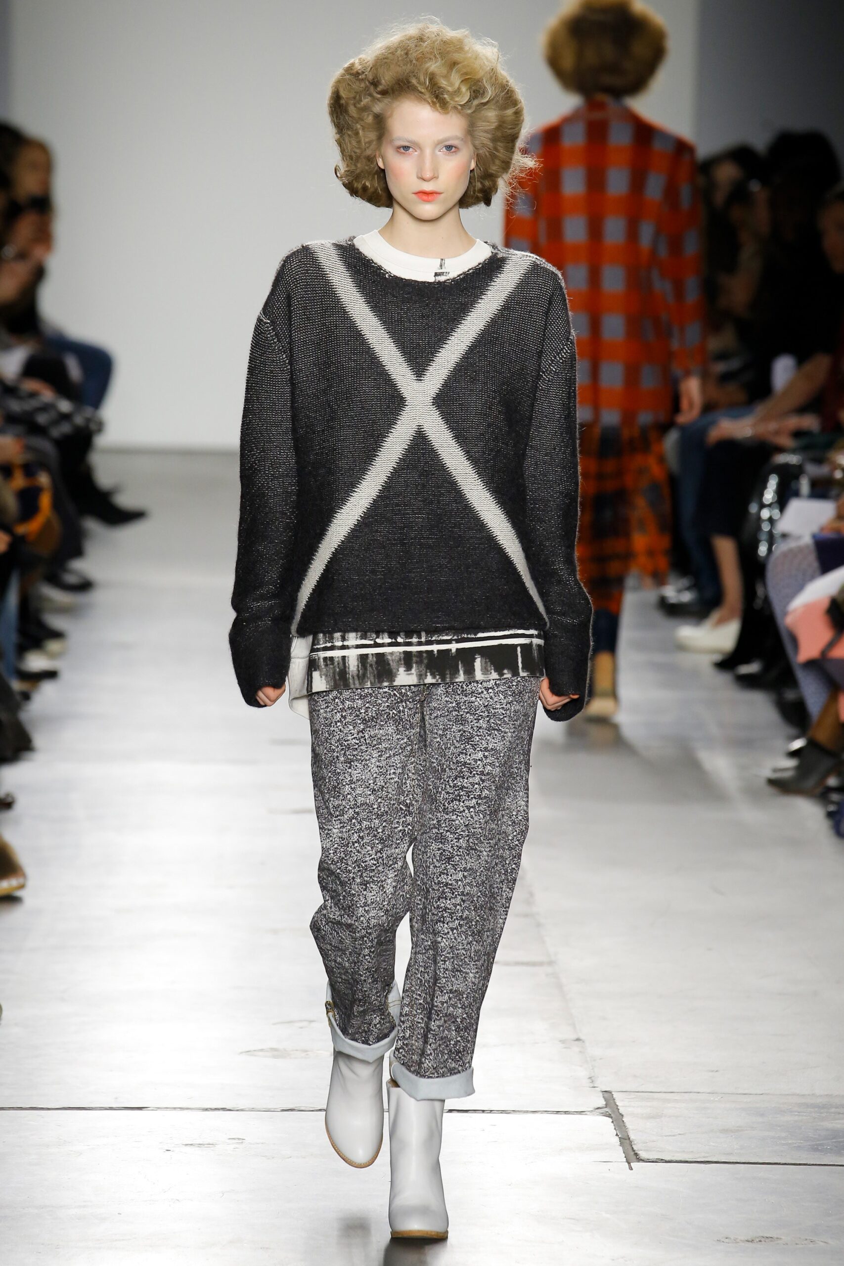 A relaxed black and gray sweater paired with comfortable pants, showcasing a stylish look.