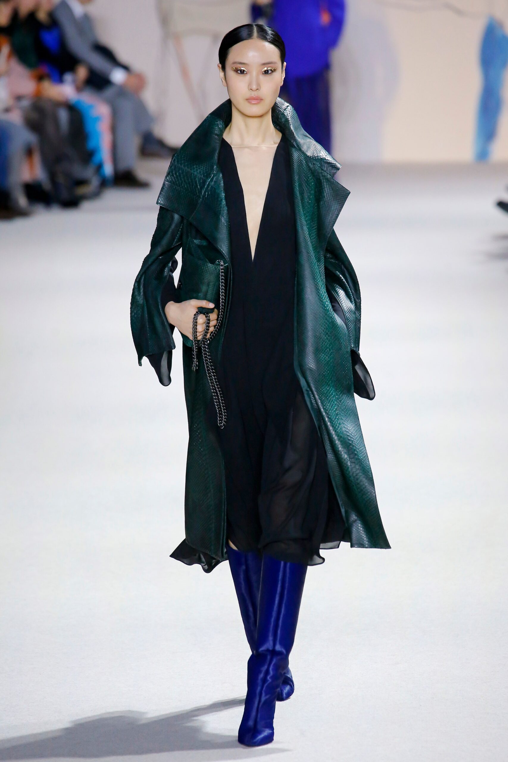 black silk sleeveless dress with green leather coat