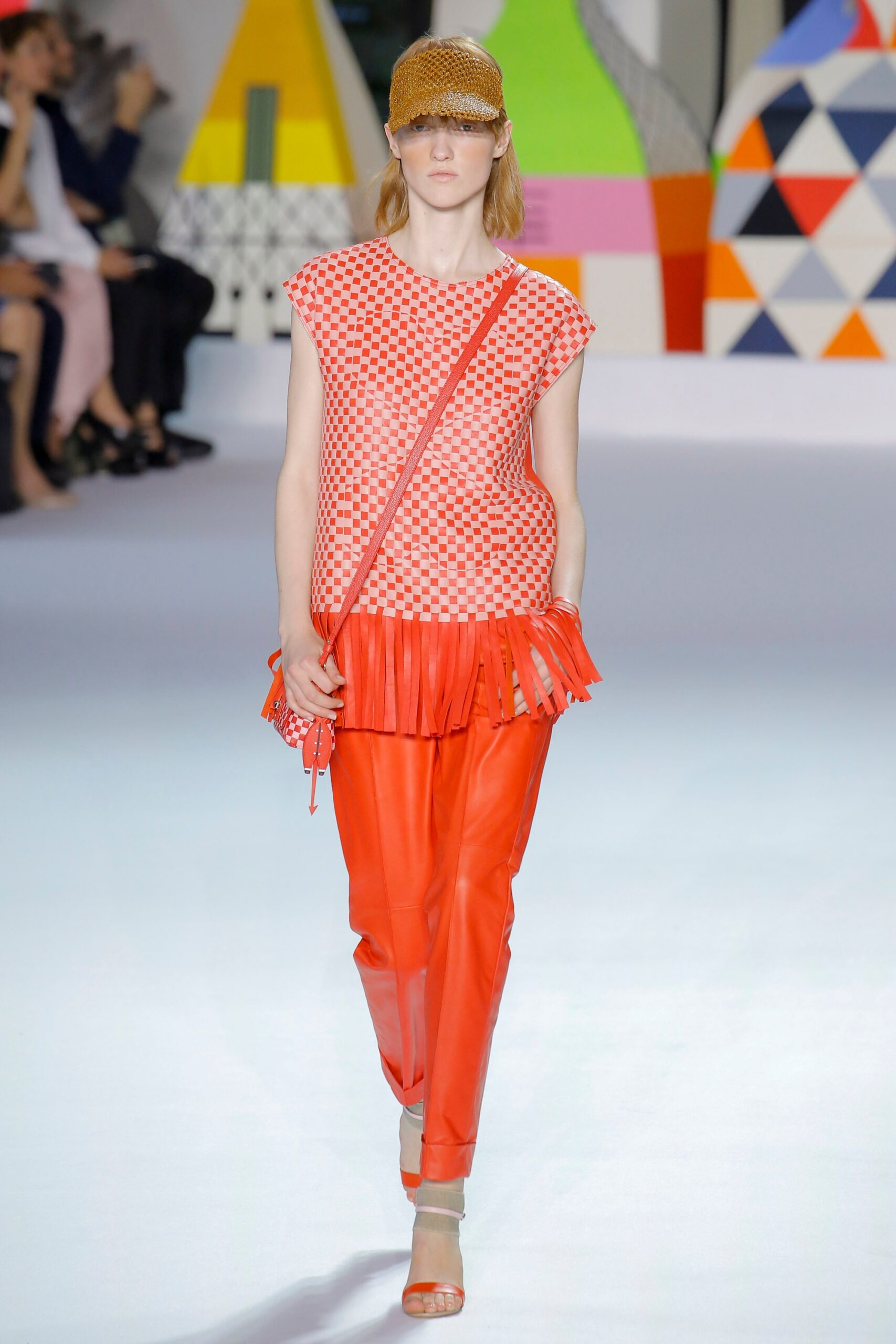 red and white ruffled top with orange pants
