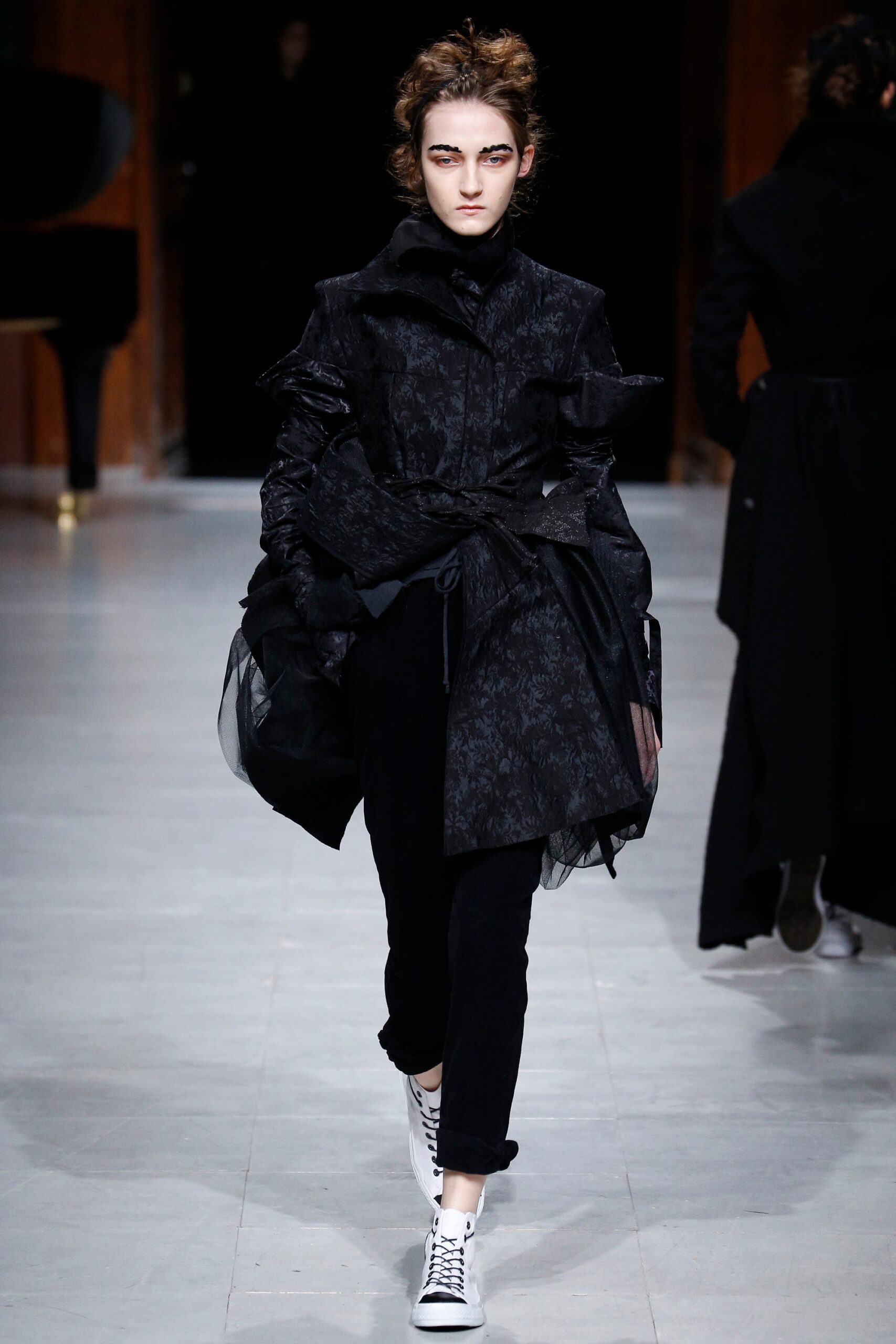black ruffled coat with slim pants