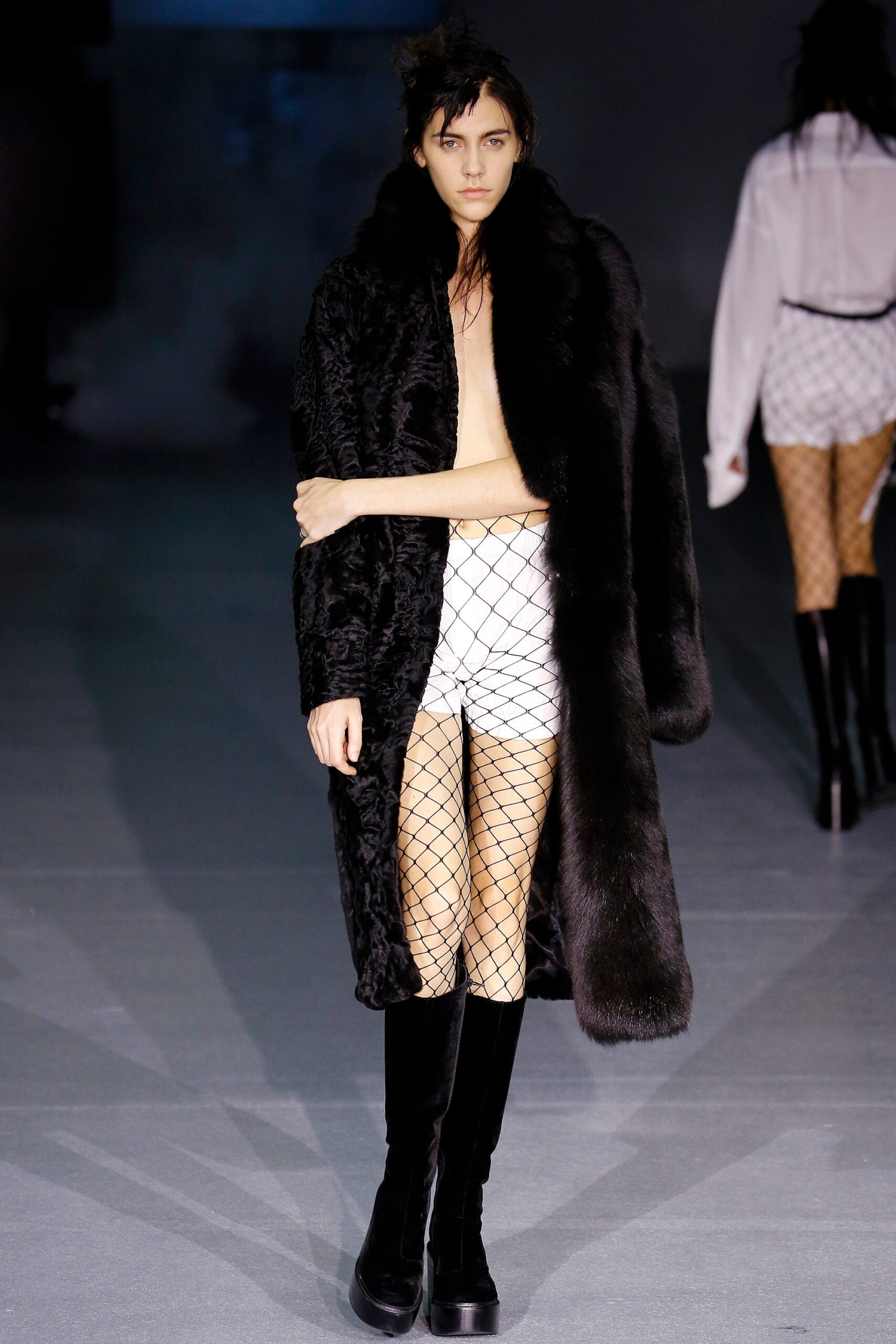 black faux-fur coat and white shorts