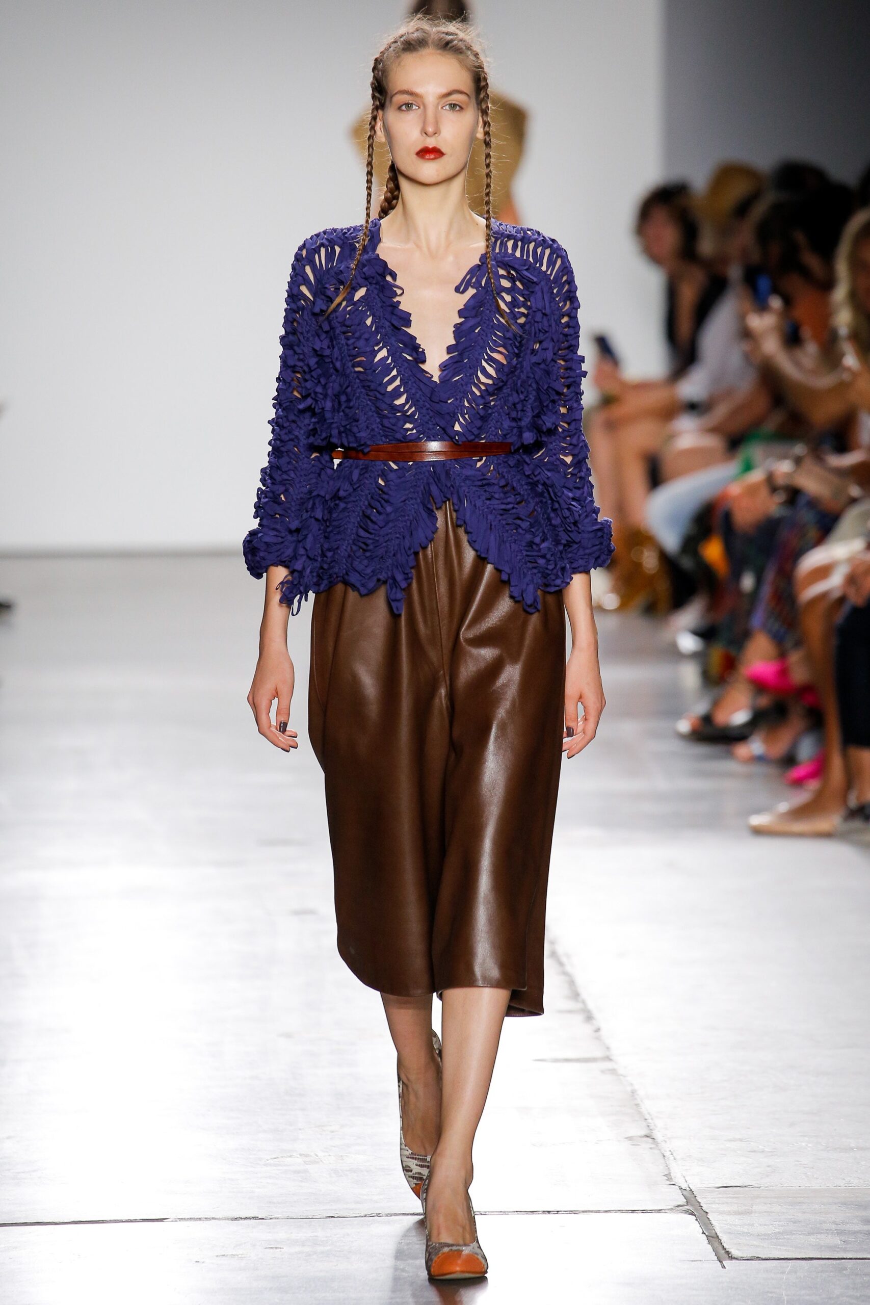 blue ruffled top with brown leather skirt