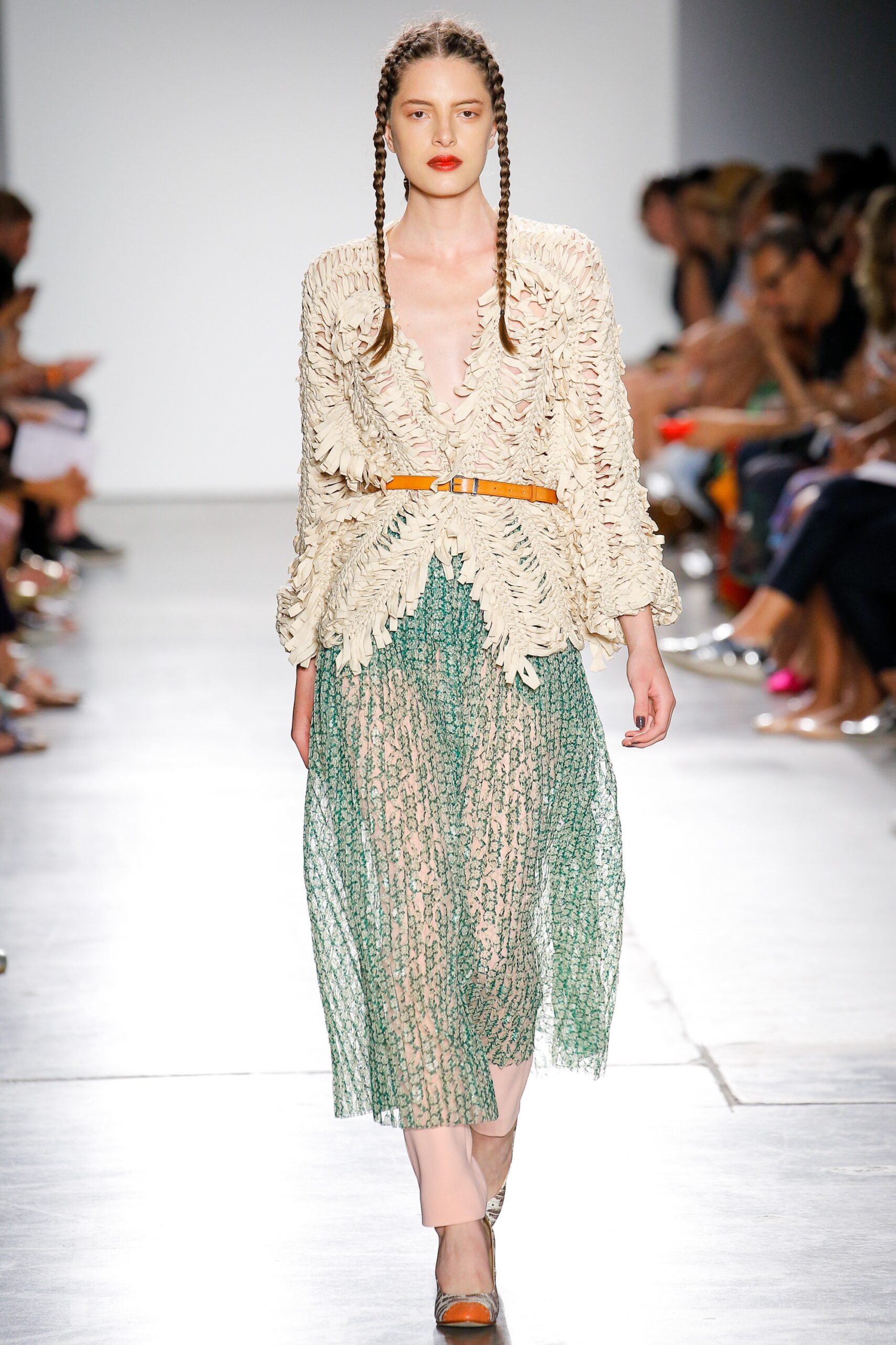 beige embroidered blouse and green pleated skirt