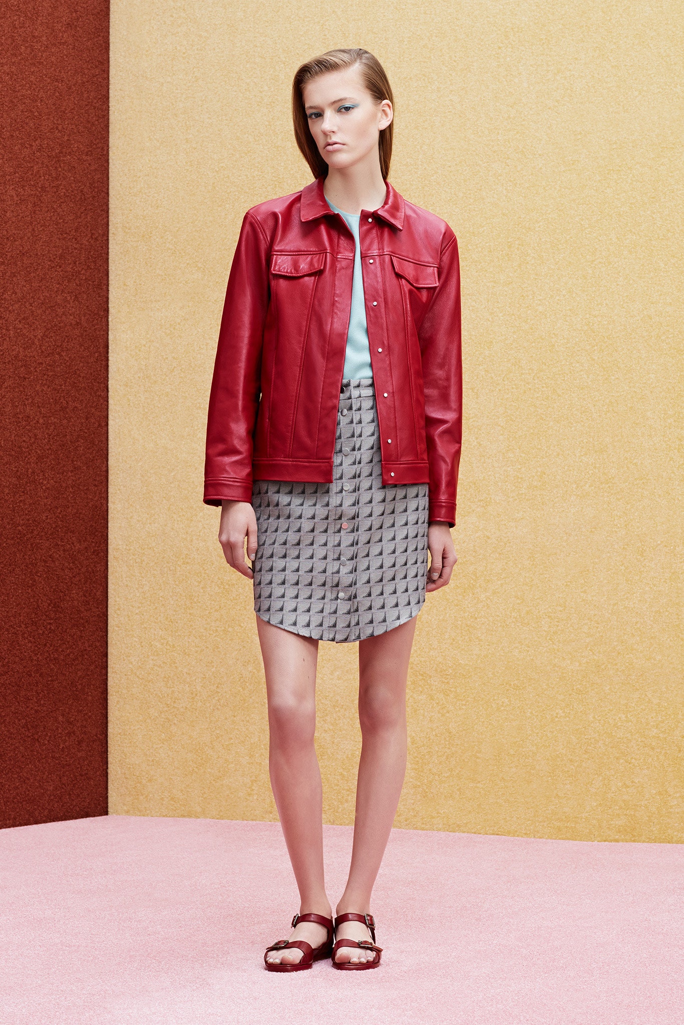 red leather jacket with gray pleated skirt