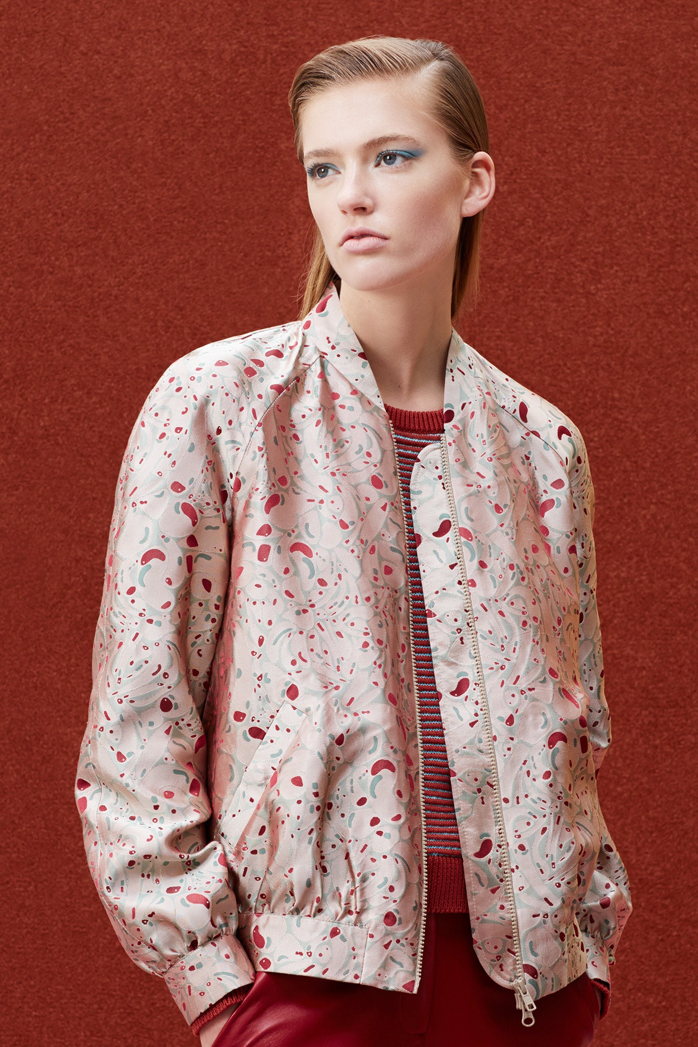 beige printed fitted jacket and red top