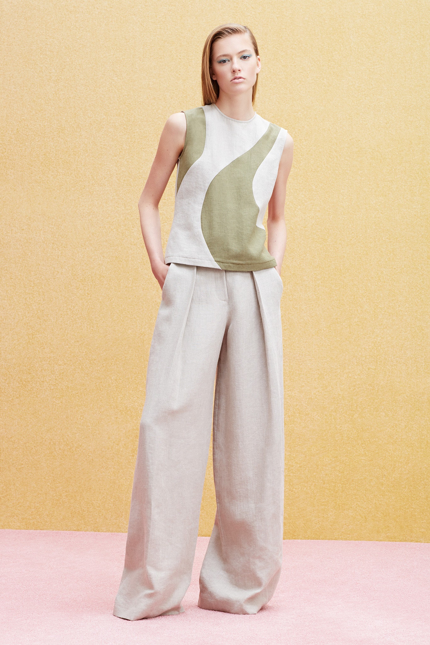 white and green sleeveless top with beige pants