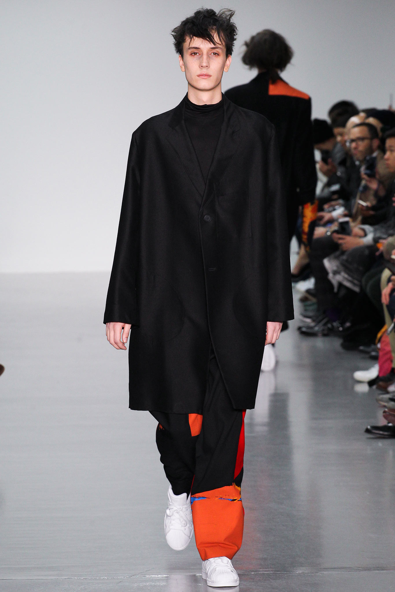 black coat with color-blocked pants