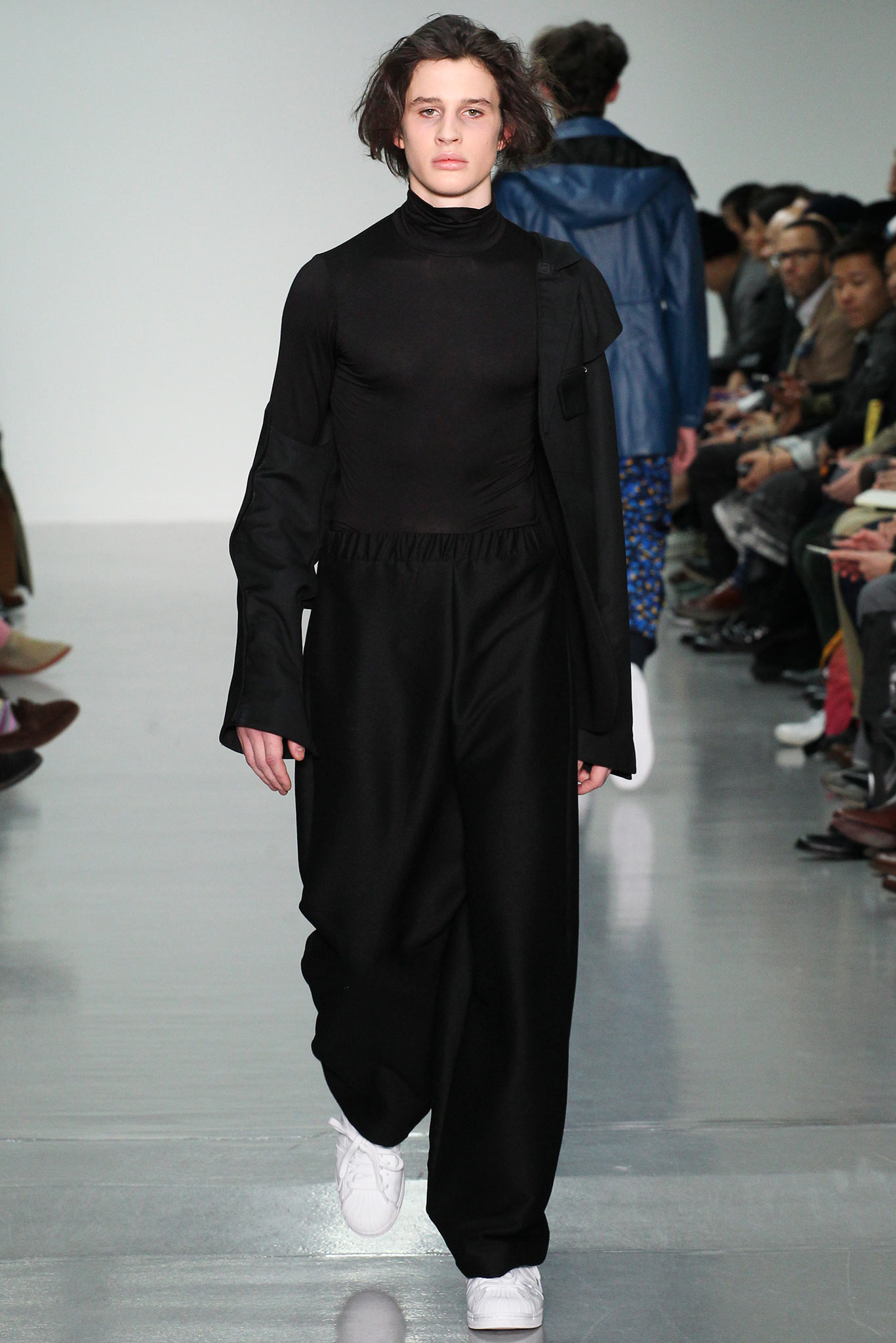 black relaxed jumpsuit with white shoes