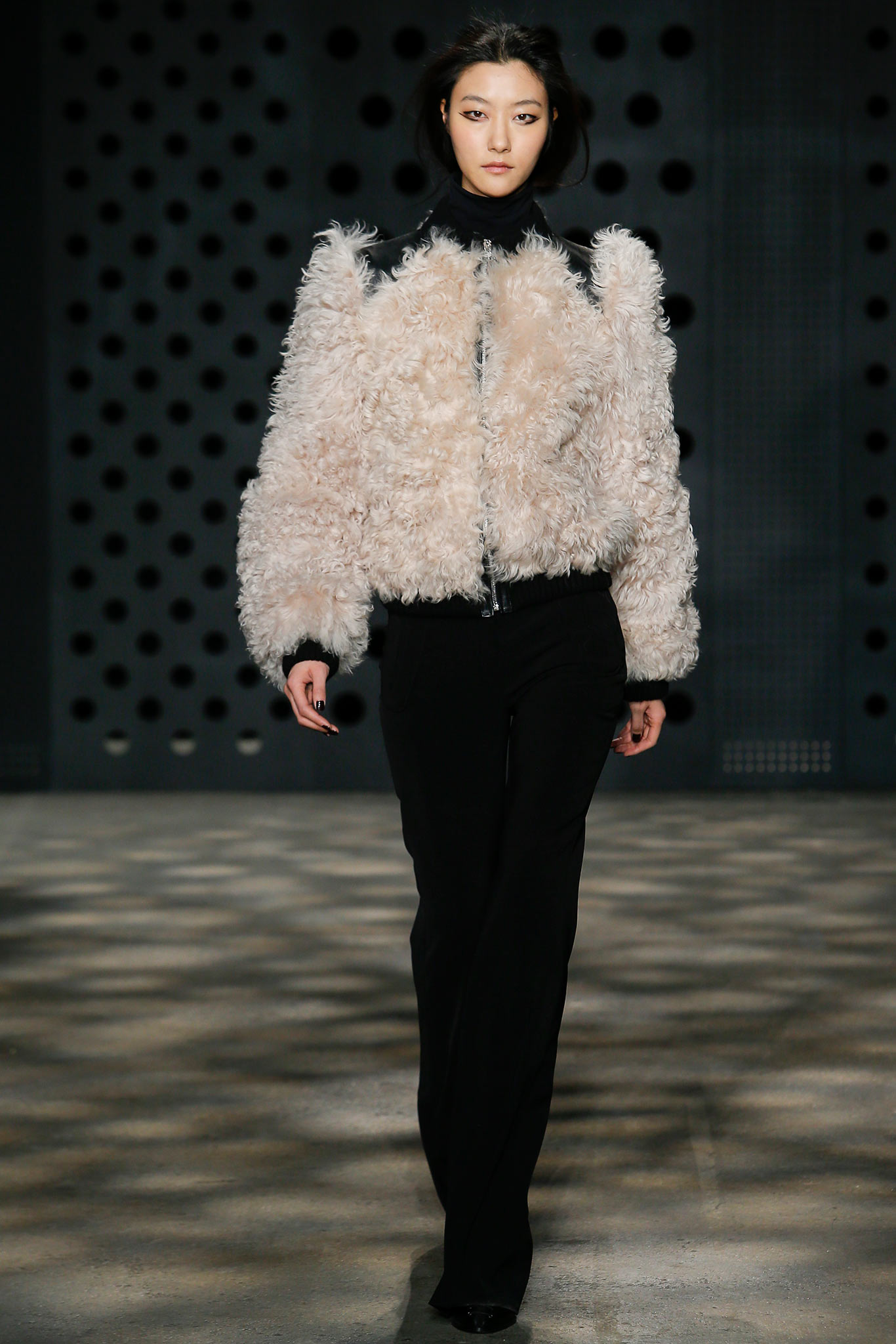 beige faux-fur jacket with black pants