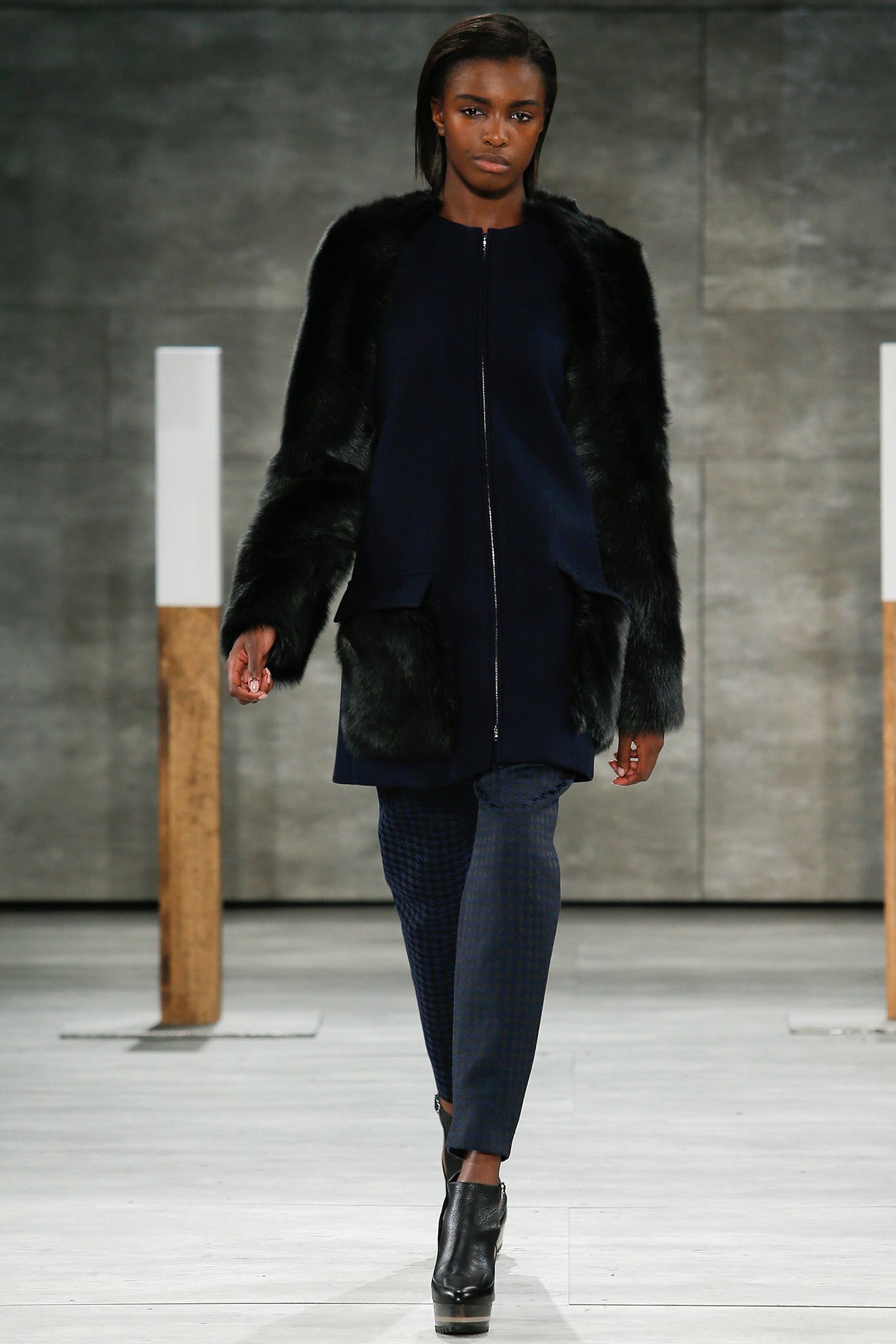 black faux-fur coat with navy dress