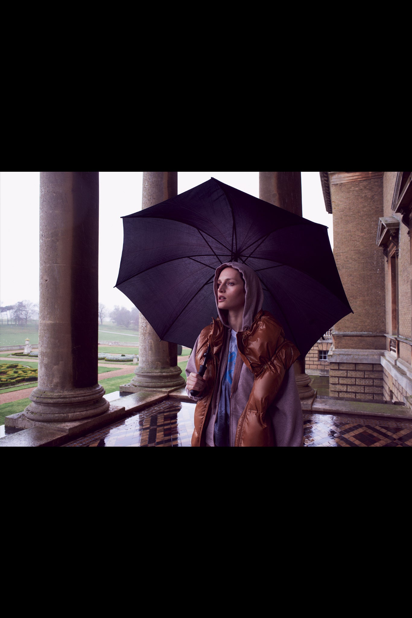 brown leather hooded coat and blue top