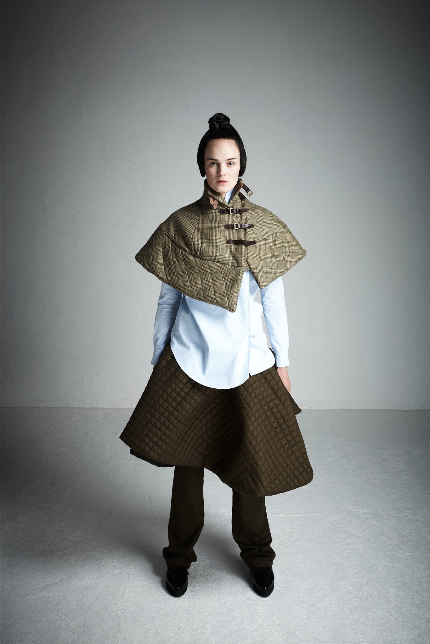green quilted cape with white shirt