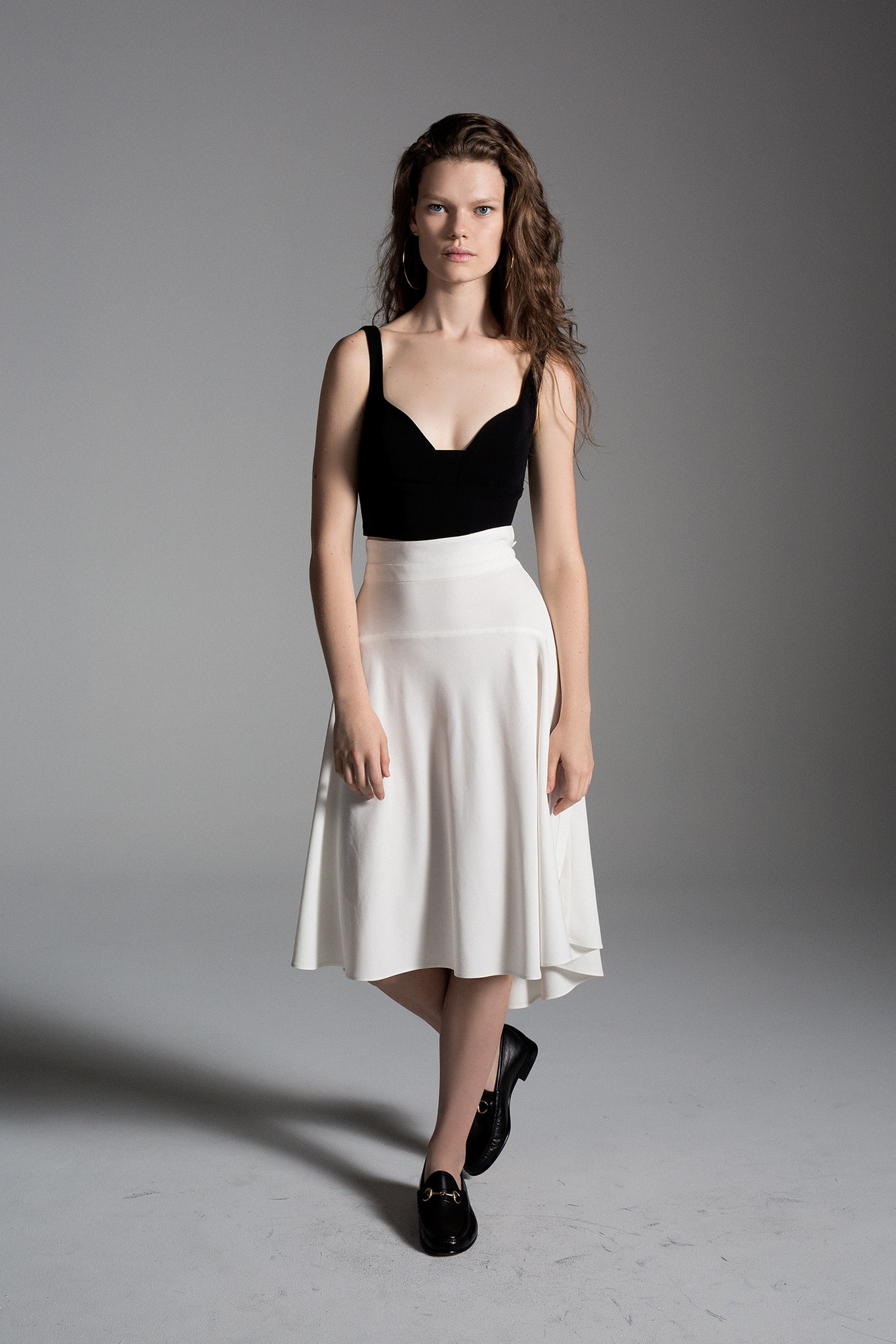 black fitted sleeveless top and white a-line skirt