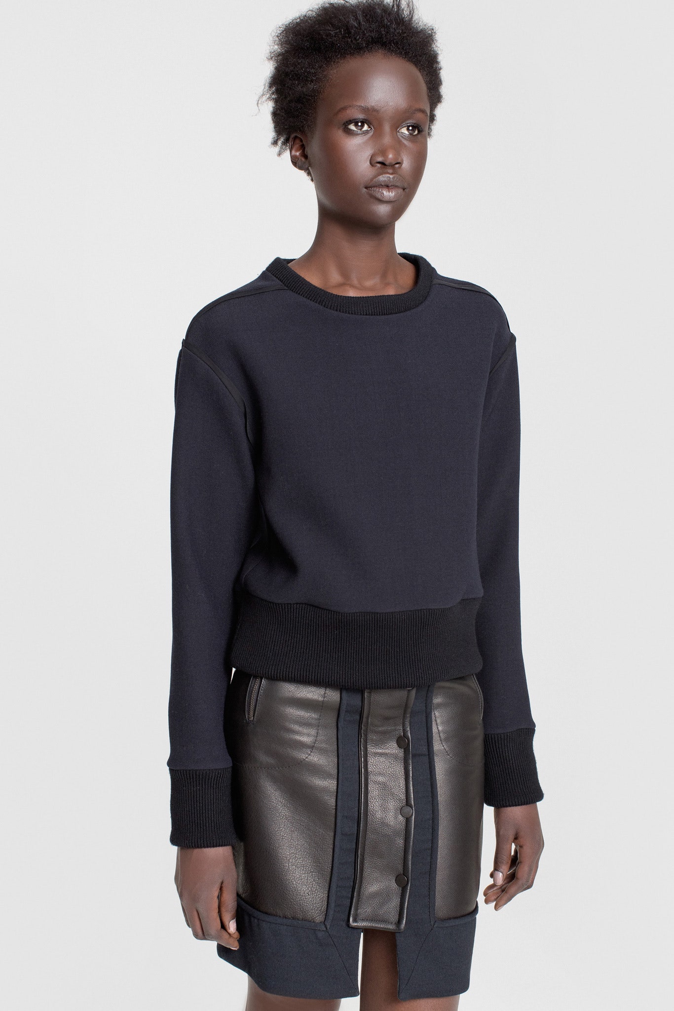 black fitted sweater and leather skirt