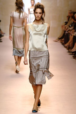 white silk sleeveless top and beige midi skirt