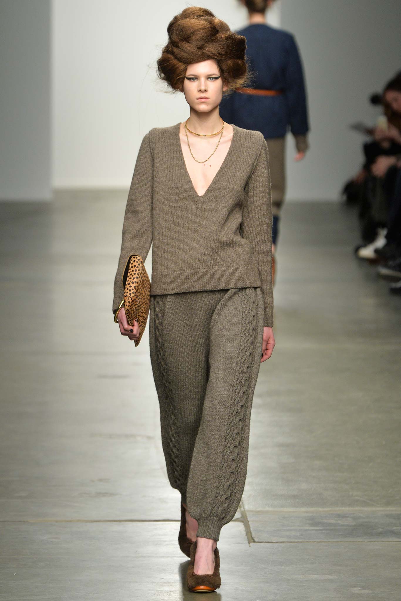 A fitted brown wool sweater with a V-neckline paired with matching knit pants.