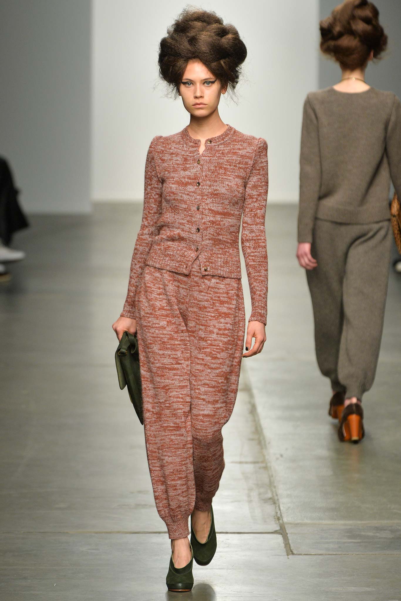 A fitted brown wool jumpsuit with long sleeves and a collared neckline featuring a straight-leg design.