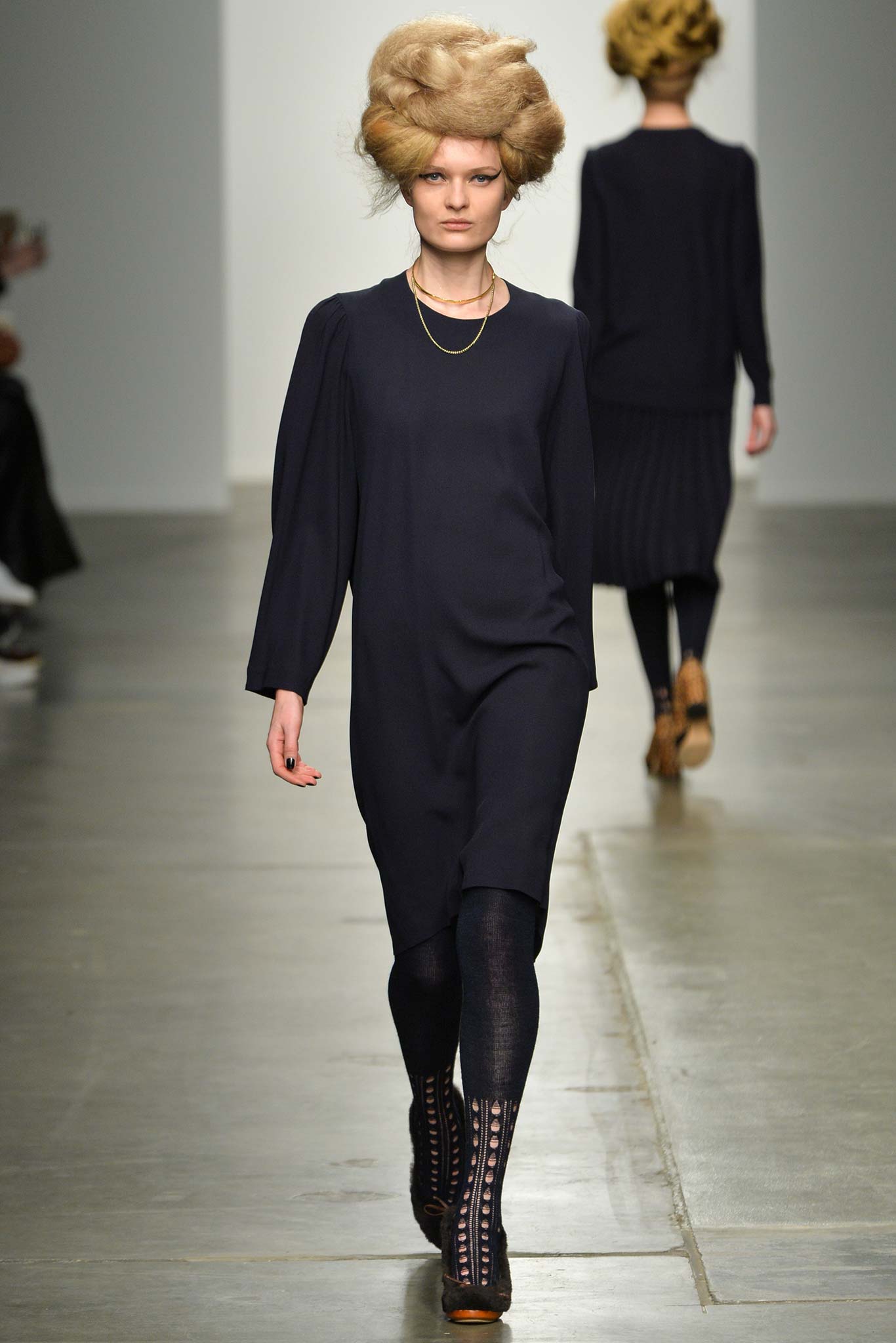 A relaxed navy long-sleeve dress with a collared neckline and straight-leg silhouette.