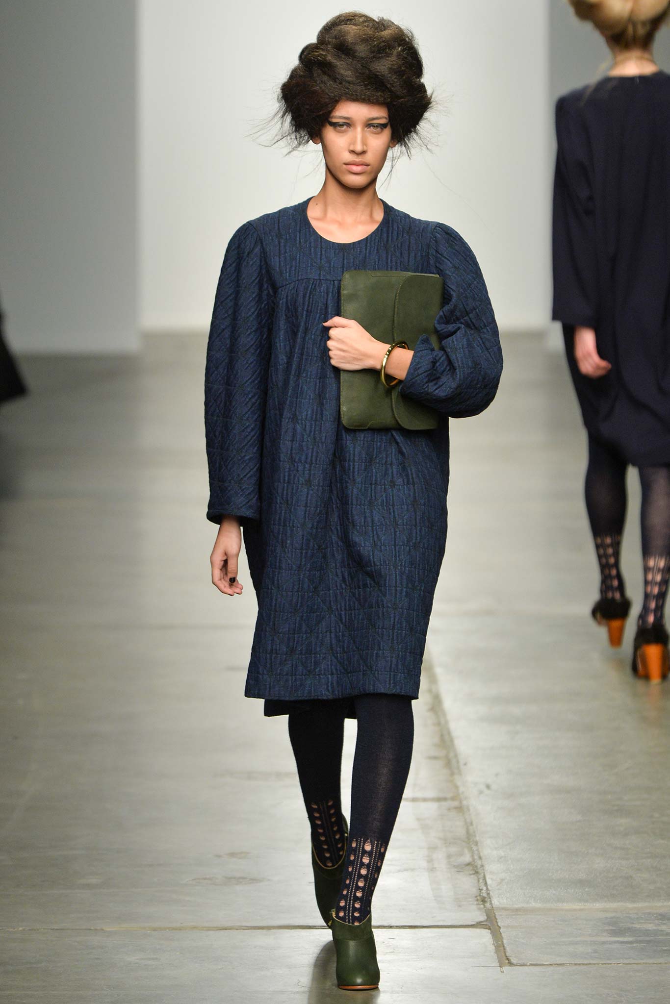 A relaxed blue cotton dress with long sleeves and a collared neckline.