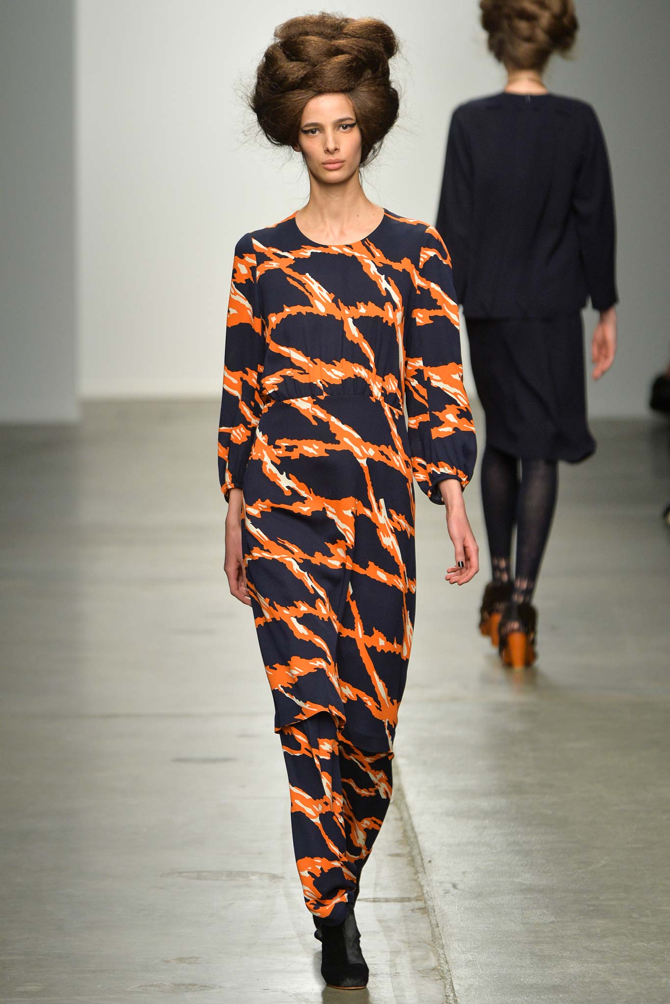A relaxed blue and orange printed dress with long sleeves and a round neckline.