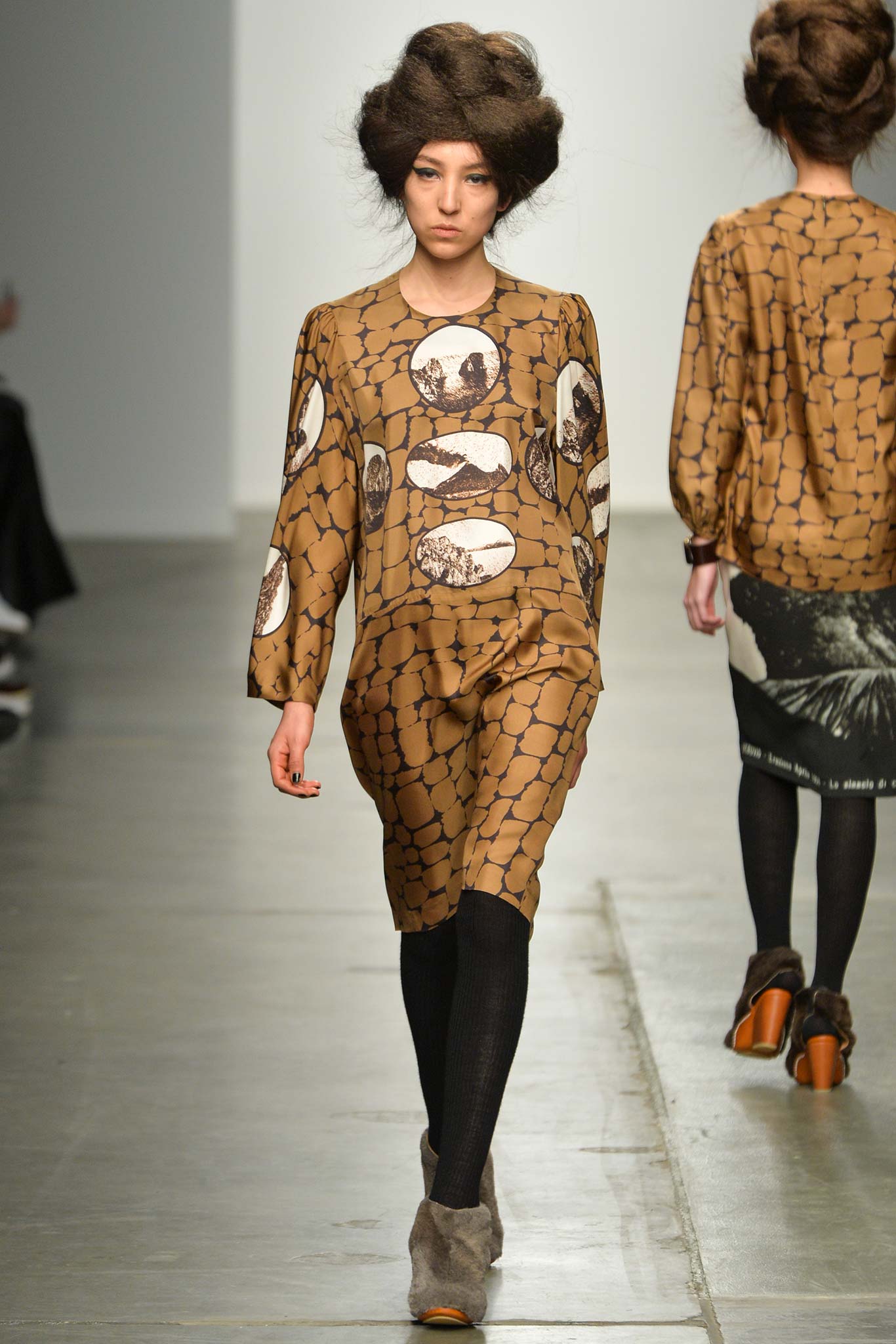 A relaxed brown cotton dress with long sleeves and a collared neckline featuring a printed design.