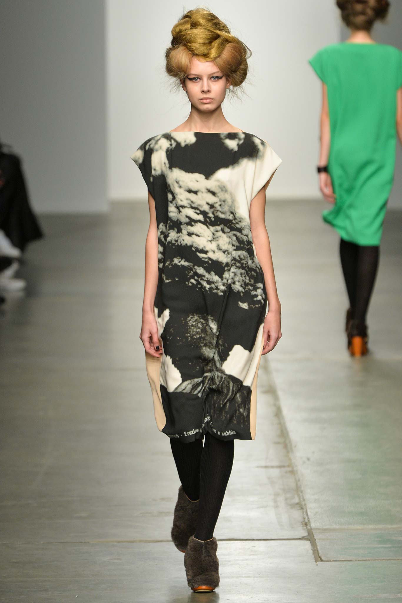 A relaxed sleeveless dress featuring a unique print in black and beige tones.