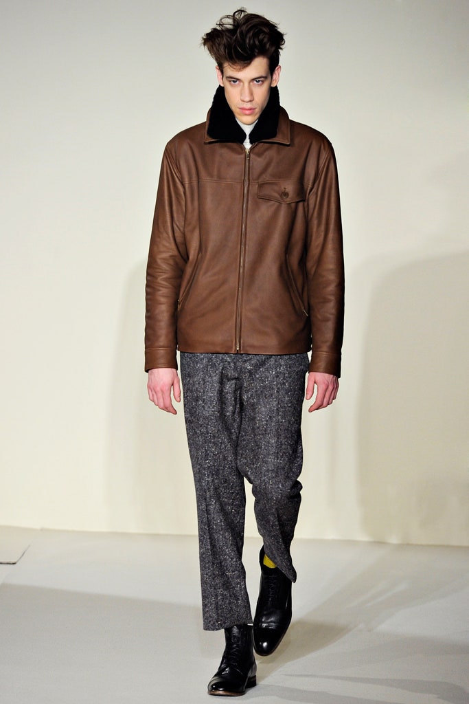 brown leather jacket and gray pants