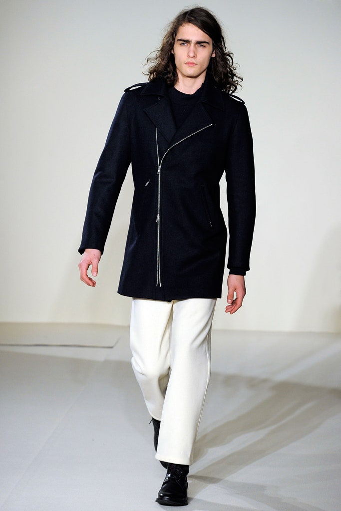 black wool fitted coat and white pants