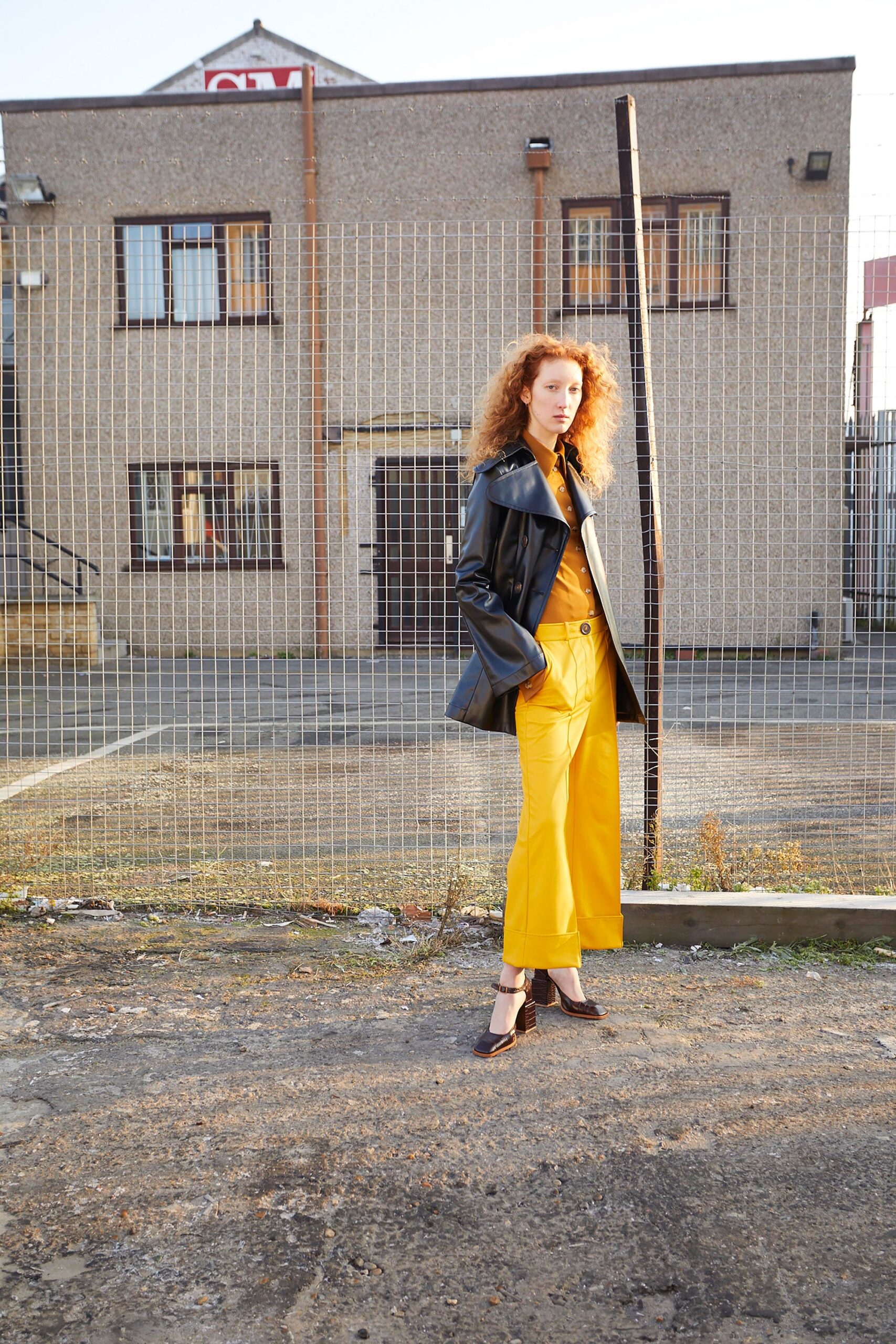 black leather long-sleeve collared oversized buttoned coat
