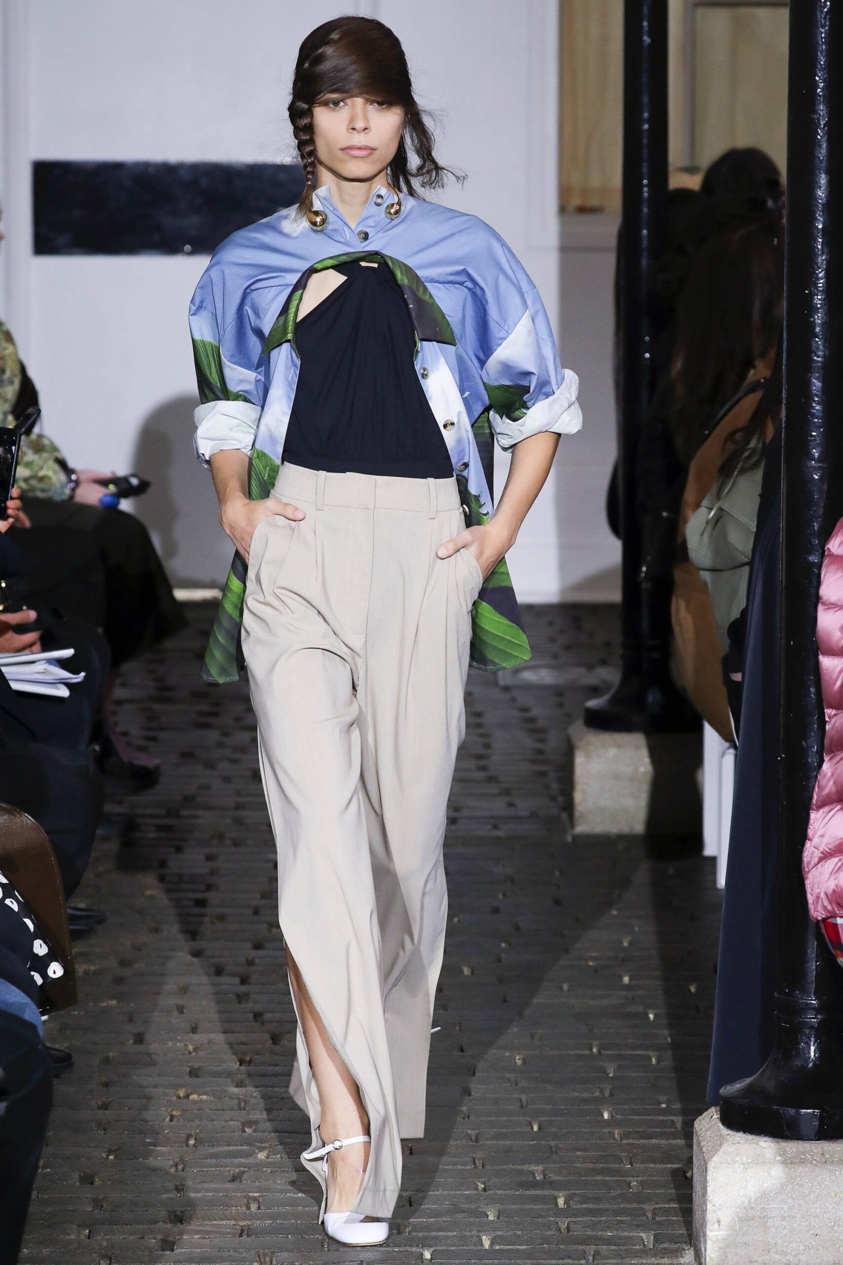 blue shirt black top beige pants