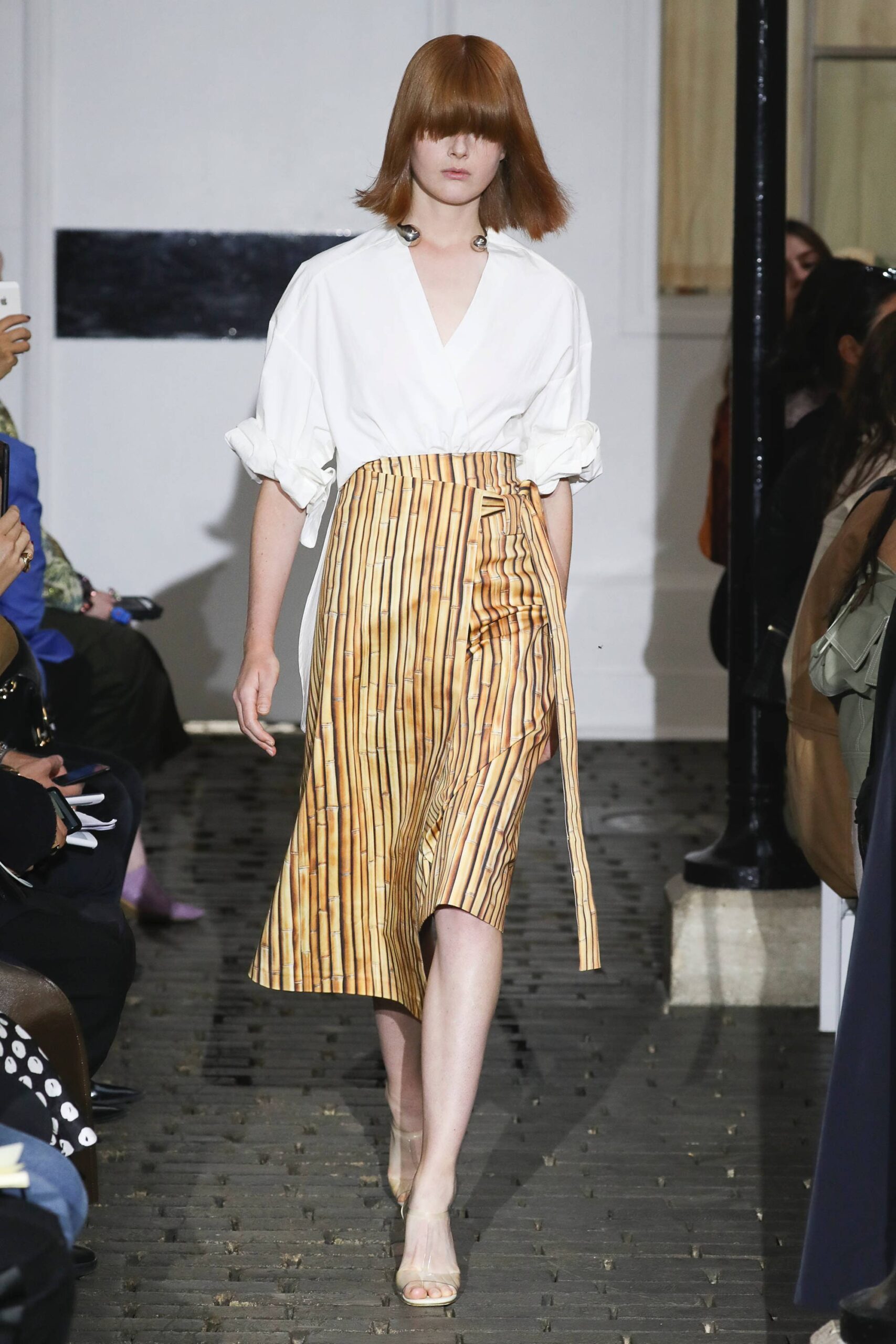 white shirt and gold pleated skirt