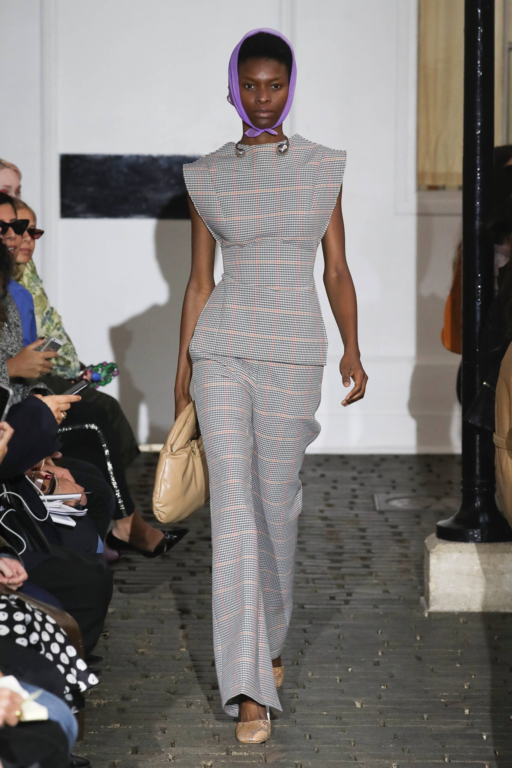 gray checked fitted jumpsuit with purple headscarf