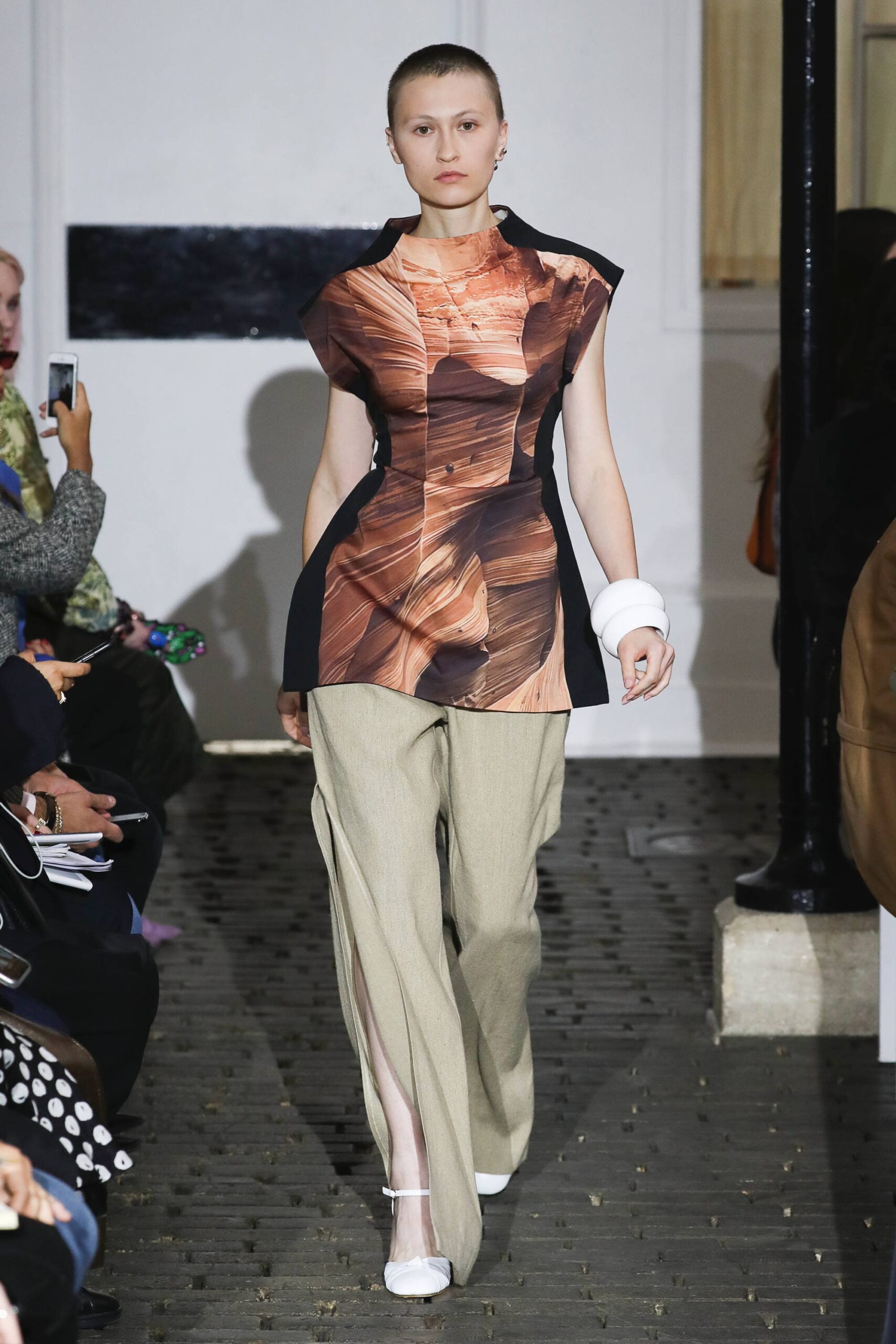 asymmetric multi-colored top with beige pants