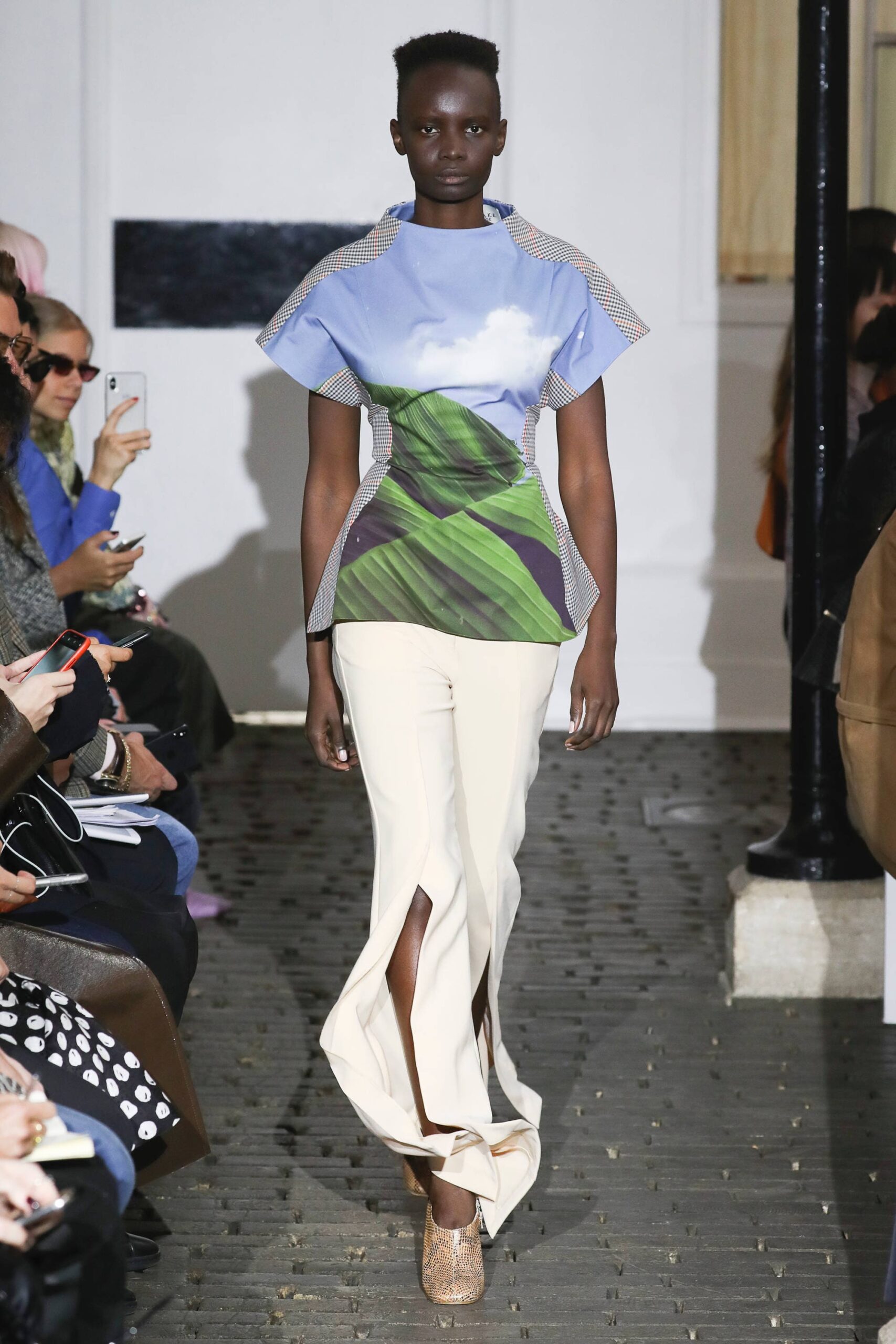 blue green fitted top with beige pants