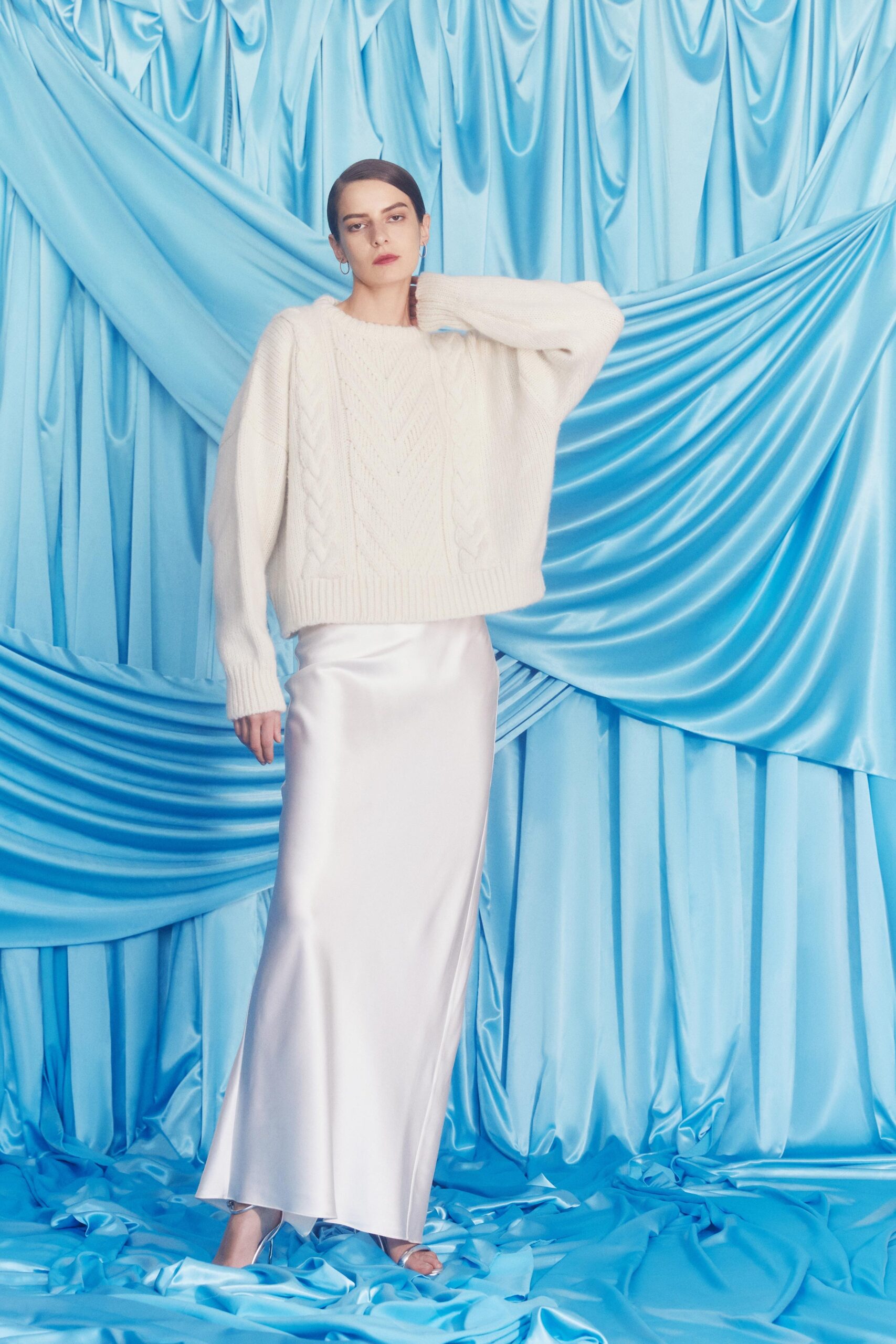 oversized white knitted sweater and silver satin skirt