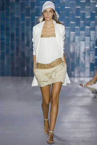 white silk blouse with beige shorts