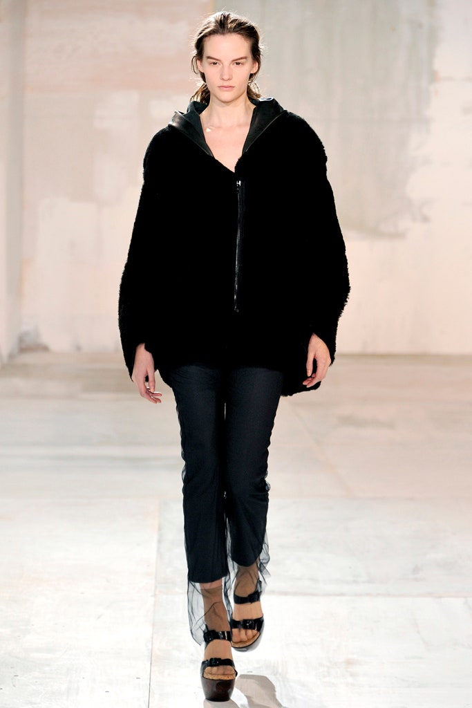 black faux-fur coat with slim pants
