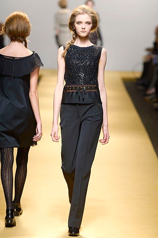 black sequined sleeveless top and tailored pants