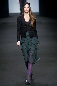black fitted jacket and green tiered skirt