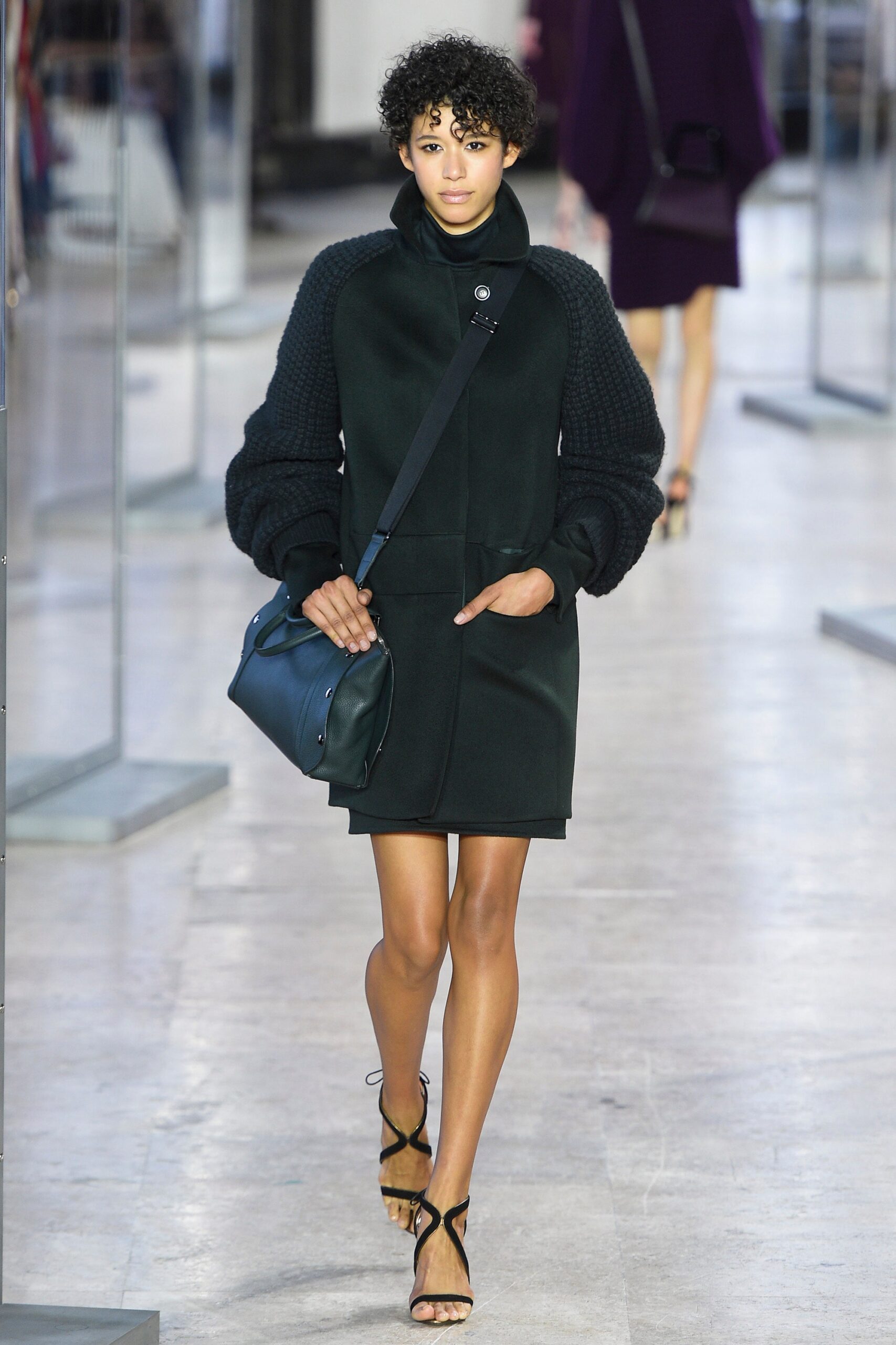 black fitted coat with strappy shoes