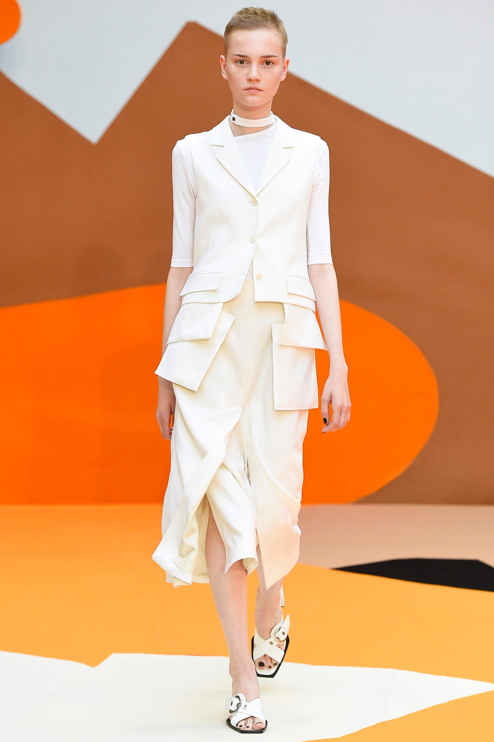 white fitted suit with asymmetric skirt