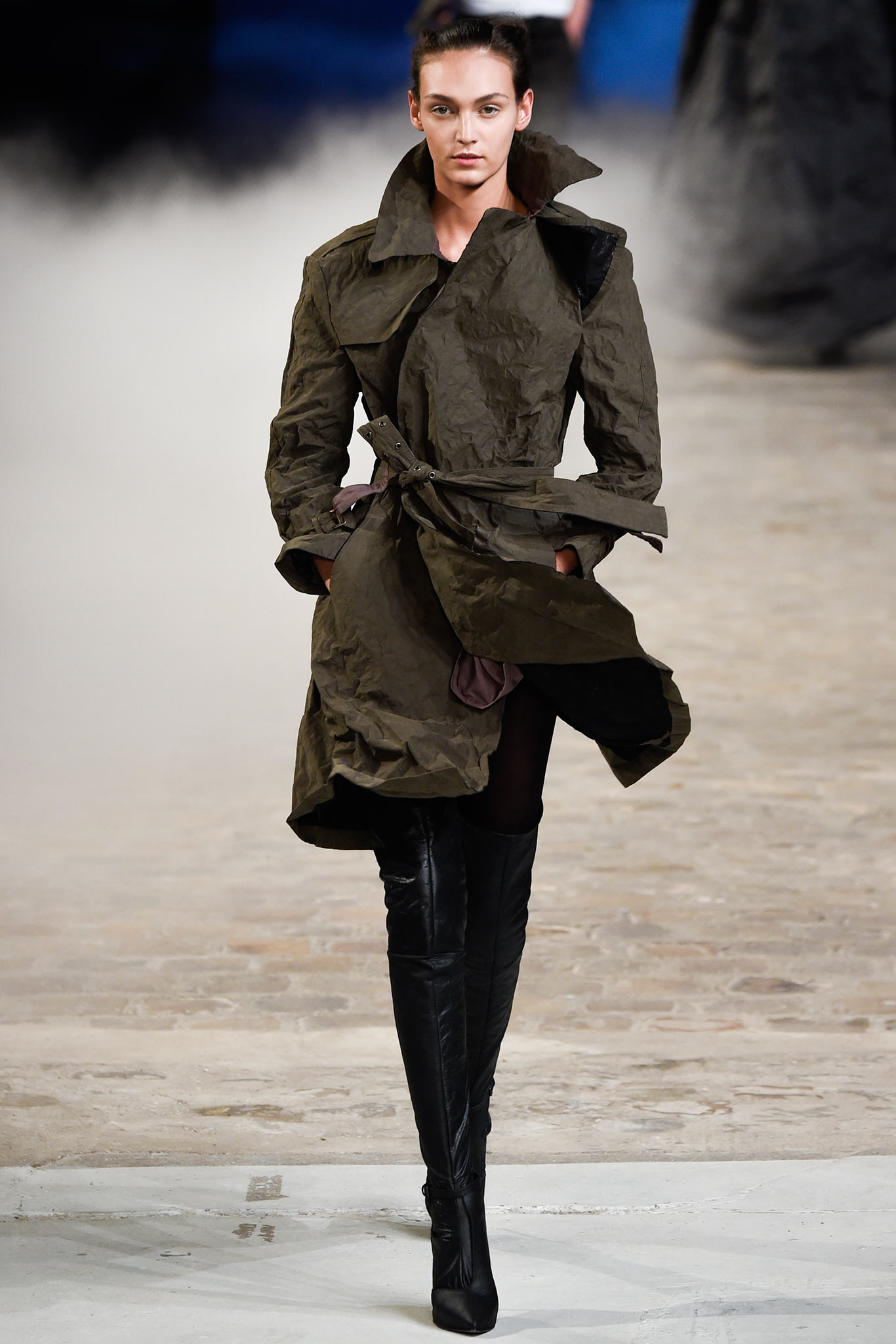 green relaxed coat with black boots