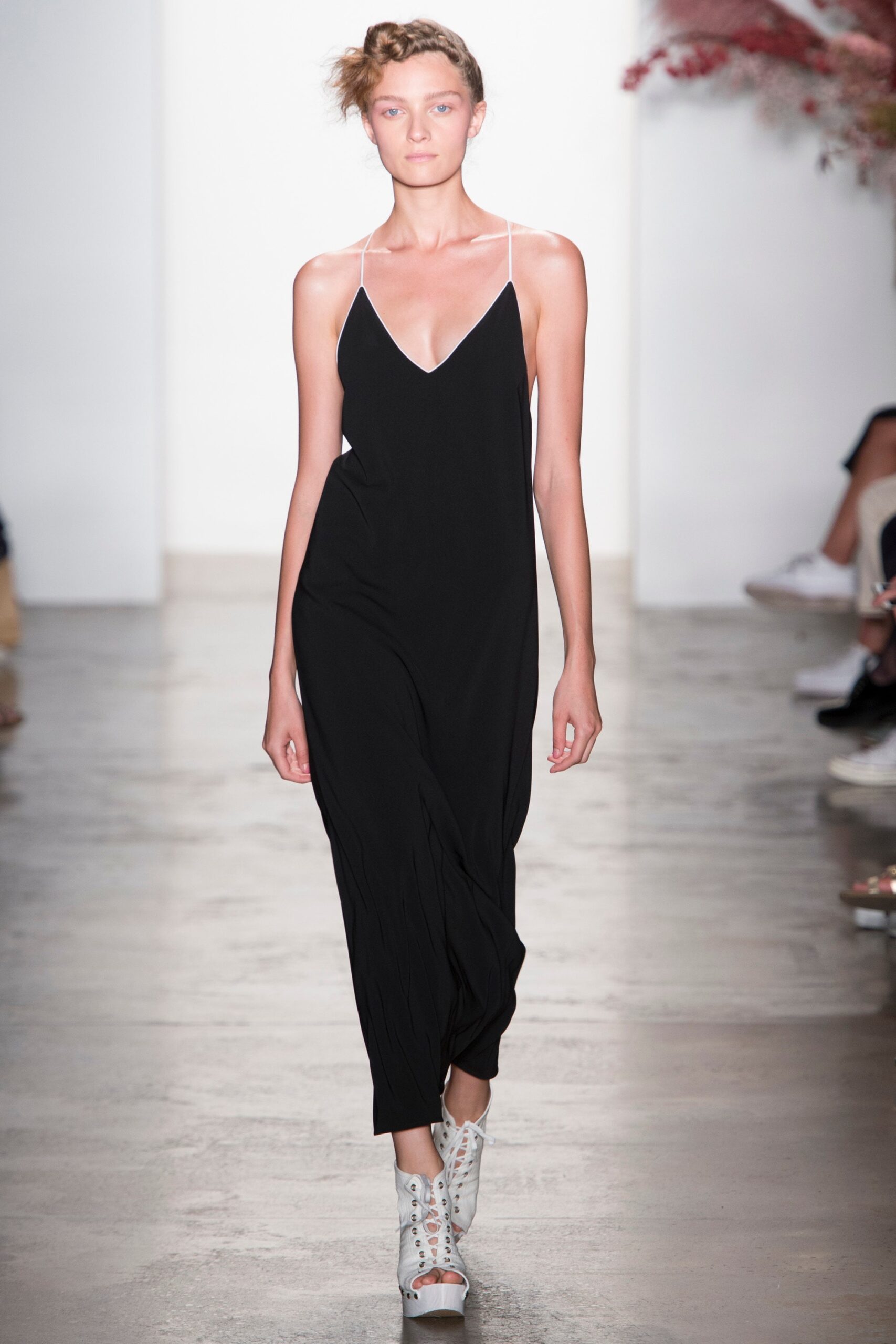 black relaxed jumpsuit with white shoes