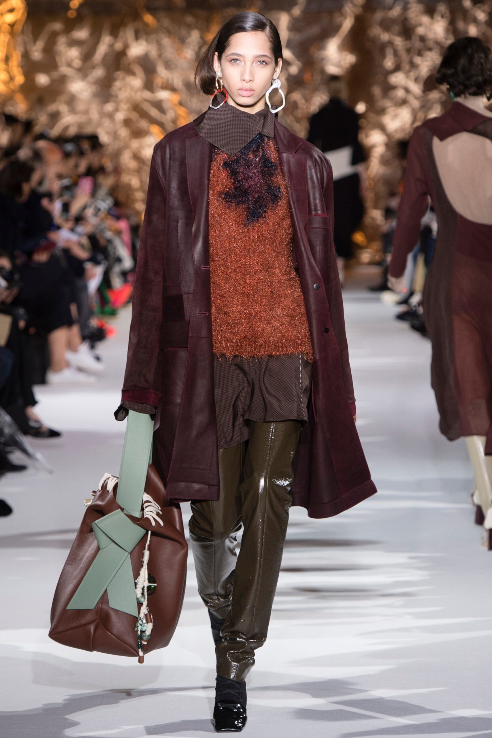 brown leather coat with orange sweater