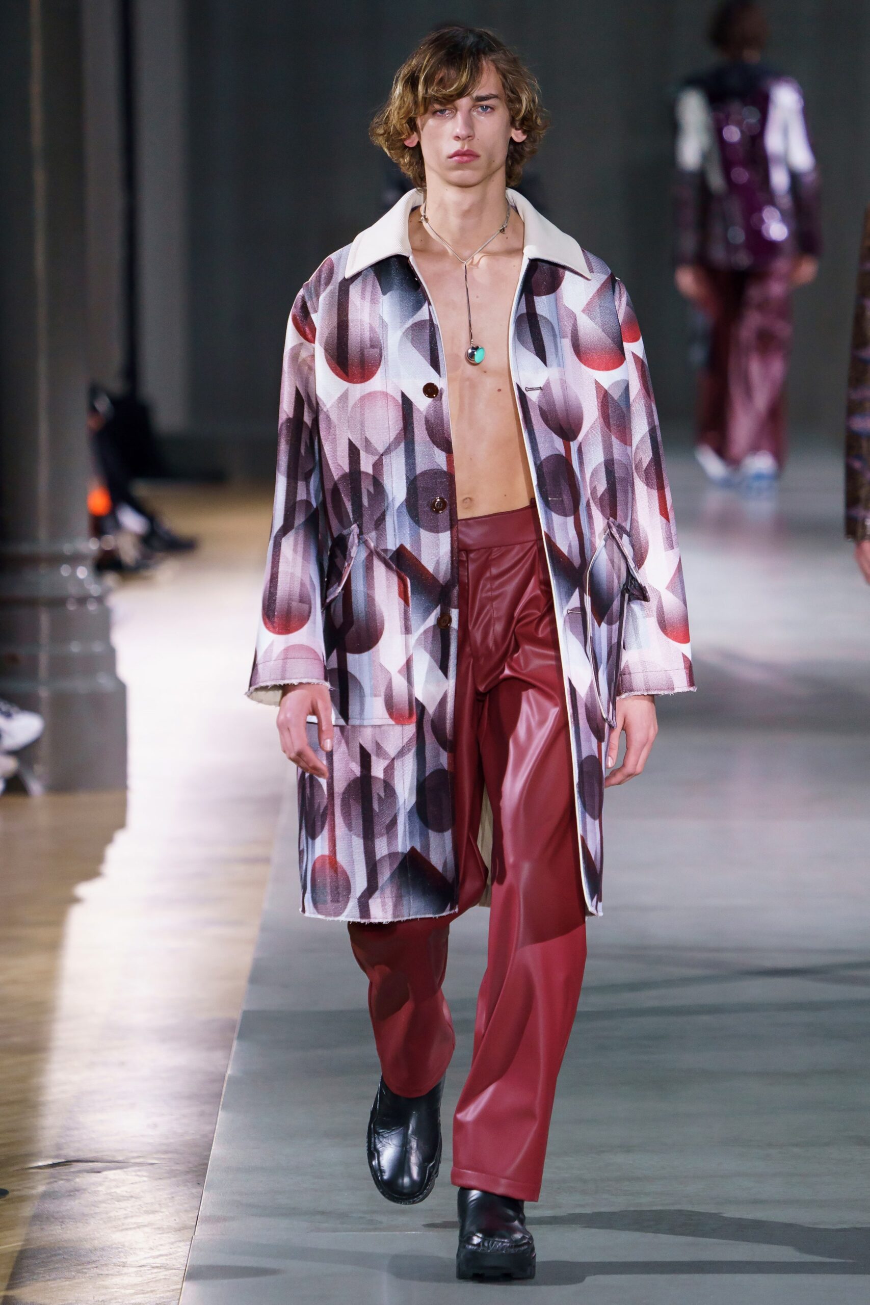 multi-colored coat with red leather pants