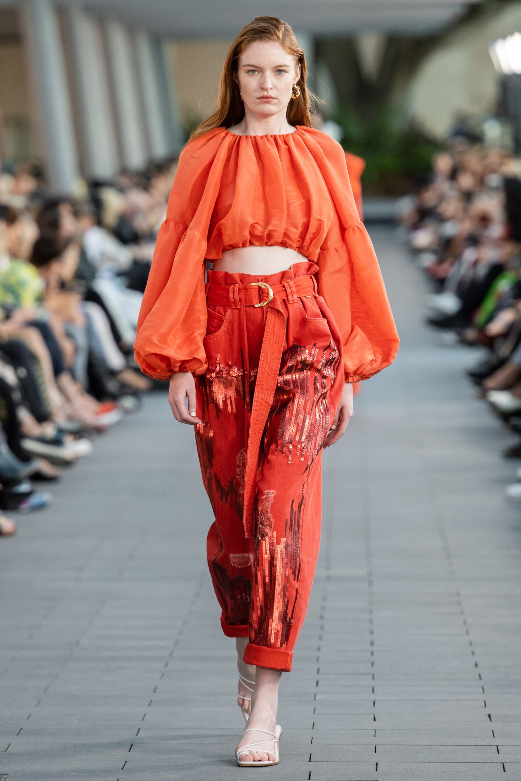 orange cropped top and red pants