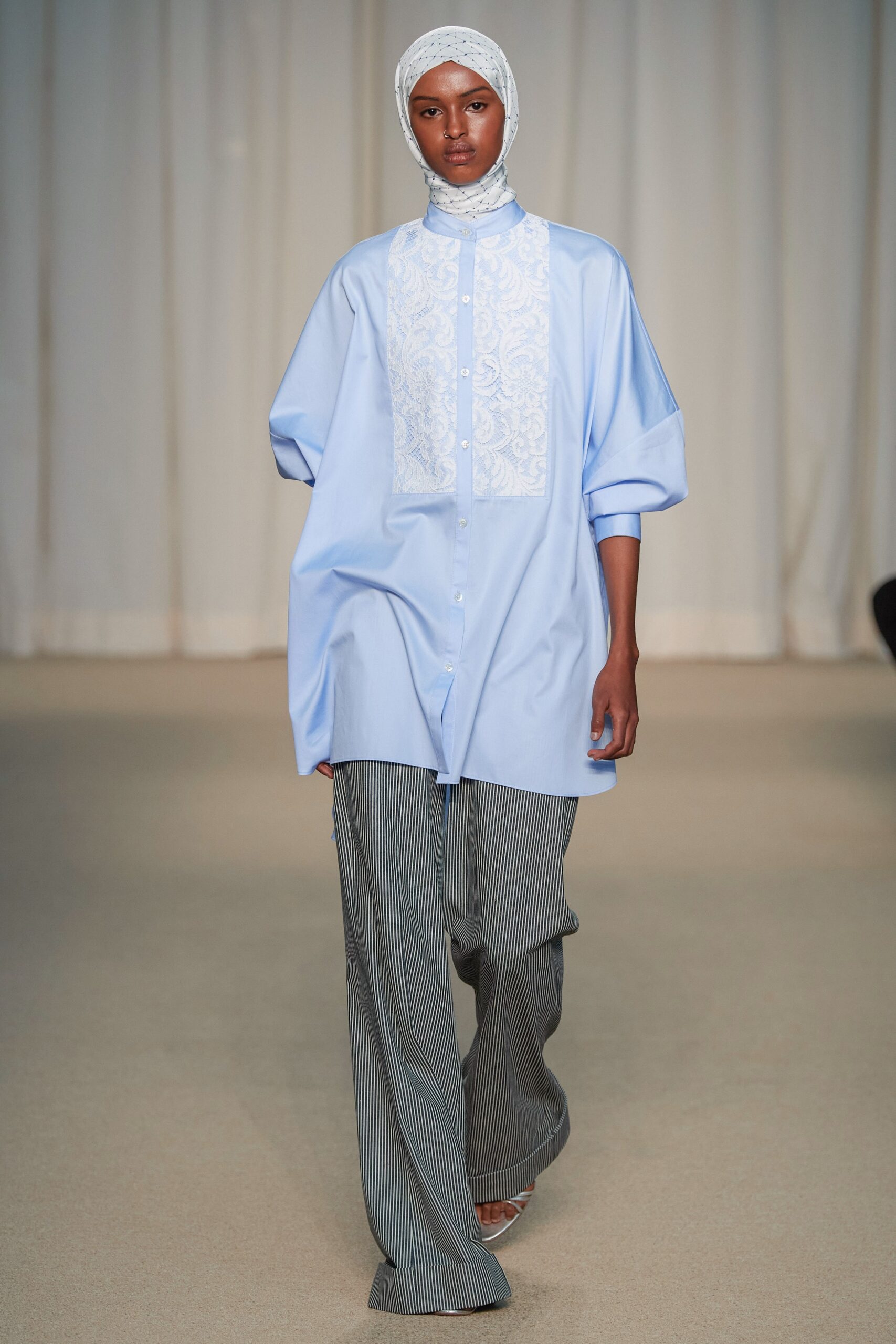 blue oversized shirt with gray striped pants